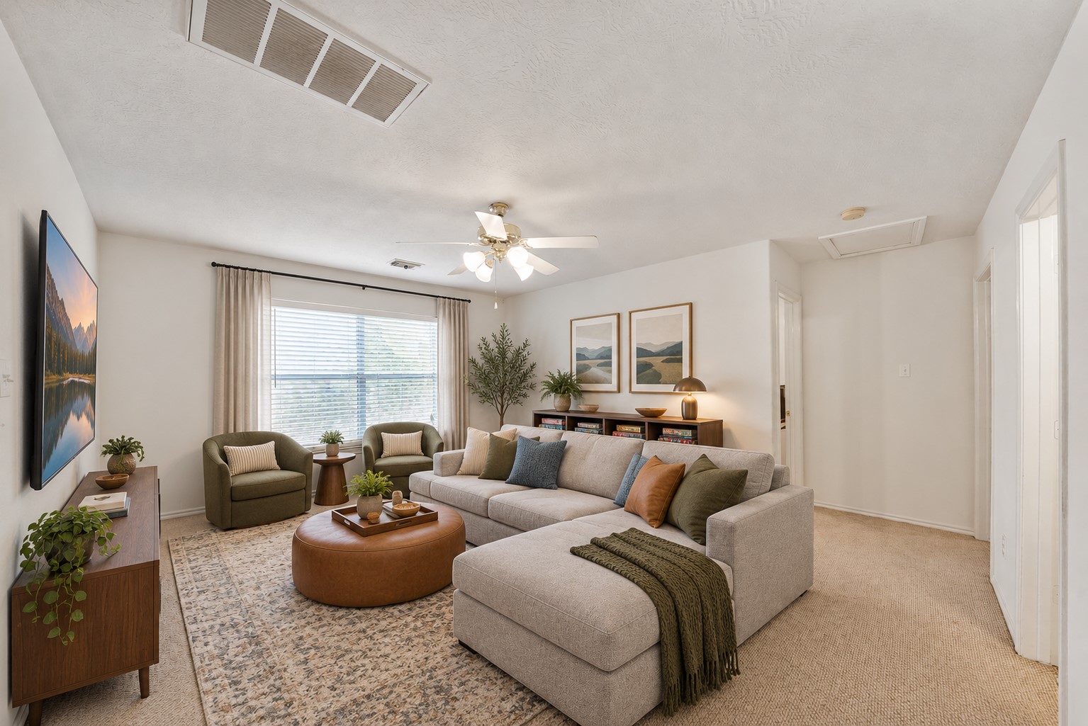 Virtually staged: The upstairs game room becomes a warm movie-and-game lounge with a large TV, cozy sectional seating, and discreet board-game storage, illustrating its potential as a relaxed second living area.