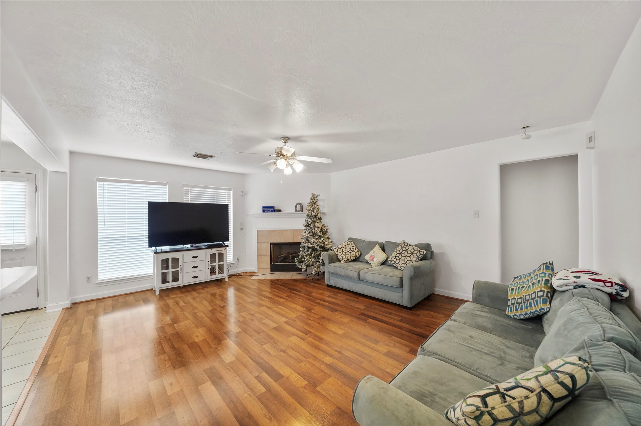 Warm laminate flooring carries through the living room, where an open layout leaves room for gathering, relaxing, and keeping conversation connected to the kitchen. Warm laminate flooring carries through the living room, where an open layout leaves room for gathering, relaxing, and keeping conversation connected to the kitchen.