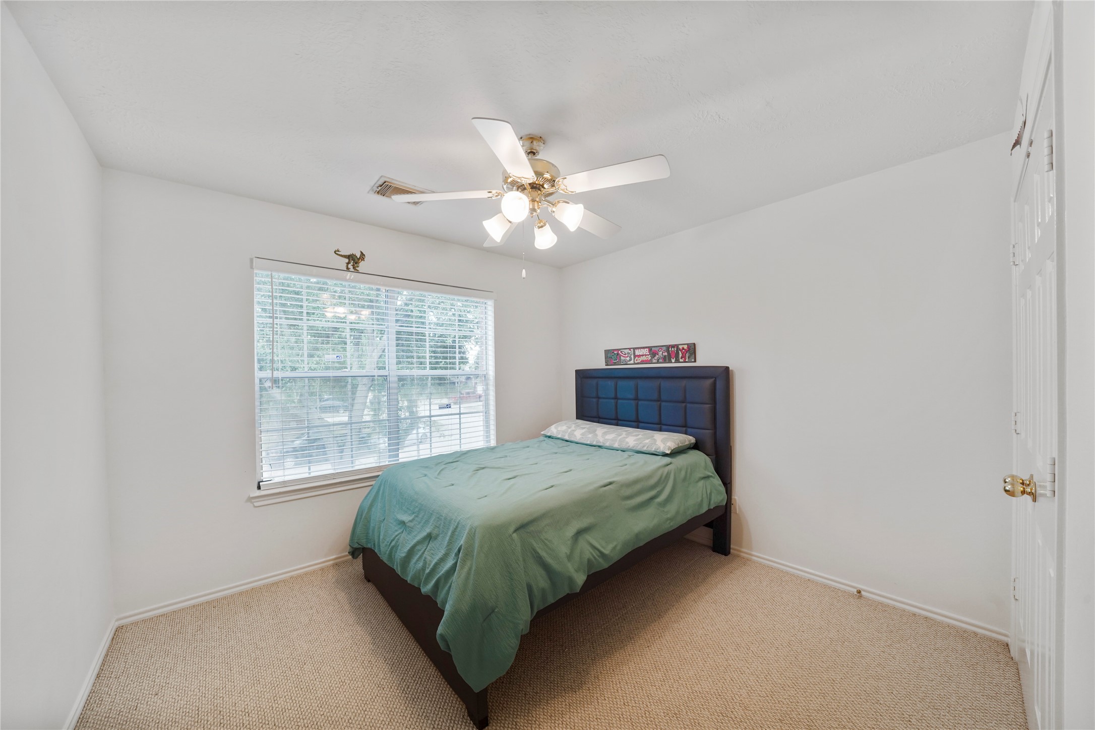 With a ceiling fan, natural light, and room to personalize, this third secondary bedroom rounds out the upstairs sleeping spaces.
