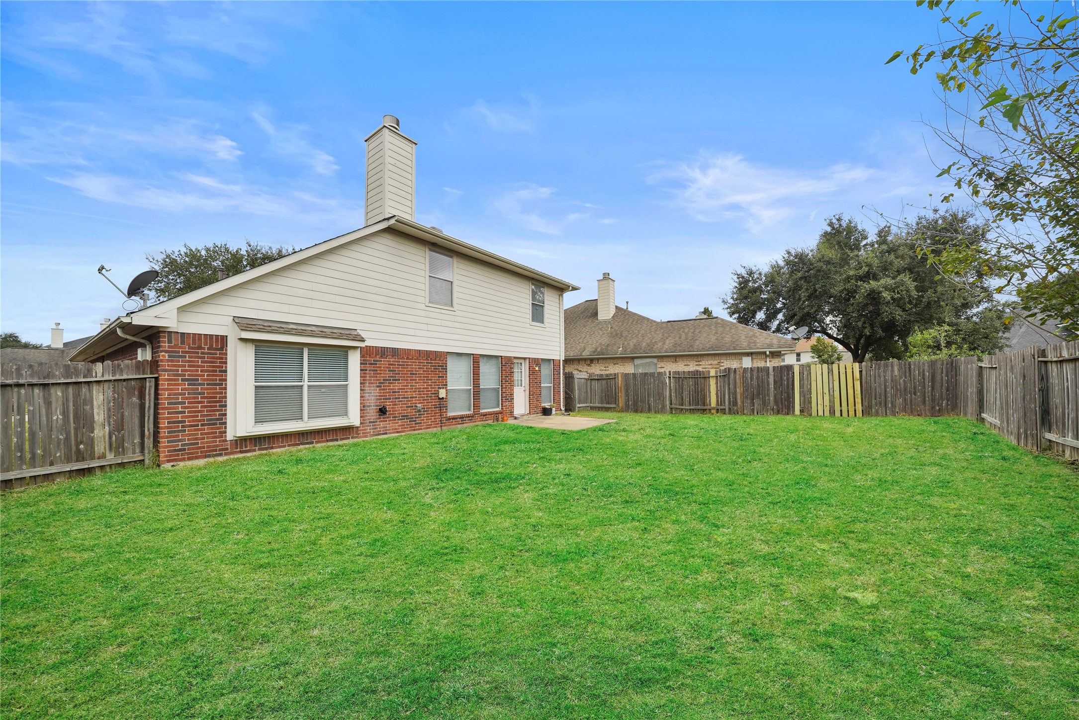 The fenced backyard opens to a broad lawn, giving you the perfect beginning for the outdoor gathering space or backyard oasis you have been imagining.
