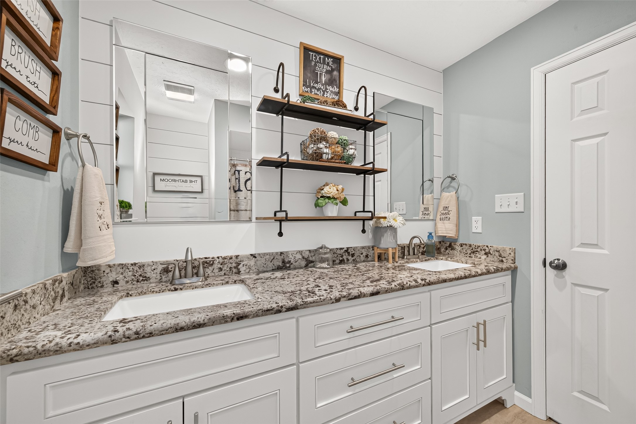 THIS BEAUTIFULLY UPDATED GUEST BATHROOM ALSO HAS A CUSTOM SHIPLAP WALL AND THE GRANITE TOPPED VANITY OFFERS PLENTY OF STORAGE. THE CUSTOM SHELF WILL REMAIN WITH HOME.