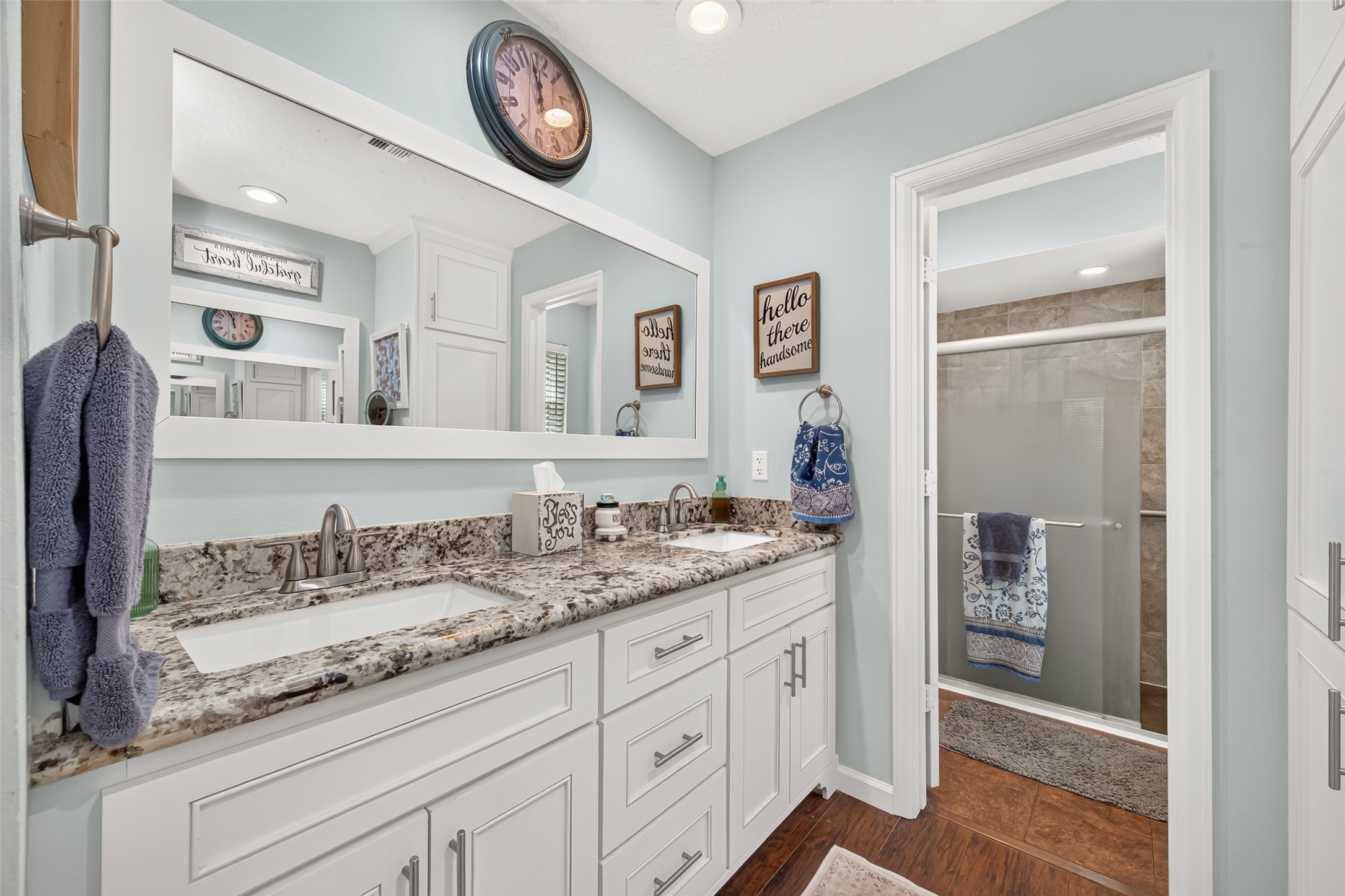 PRIMARY BATHROOM WITH DOUBLE SINKS, GRANITE COUNTERTOPS, LOTS OF CABINET SPACE AND ENTRY TO THE SHOWER AND TOILET;