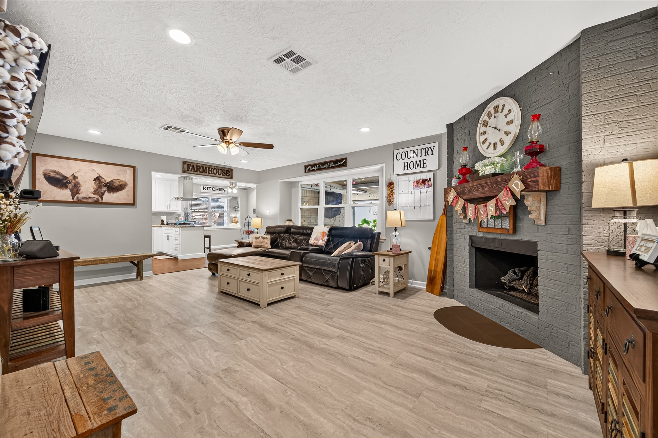 ANOTHER VIEW OF THE SPACIOUS LIVING ROOM LOOKING INTO THE KITCHEN/BREAKFAST ROOM