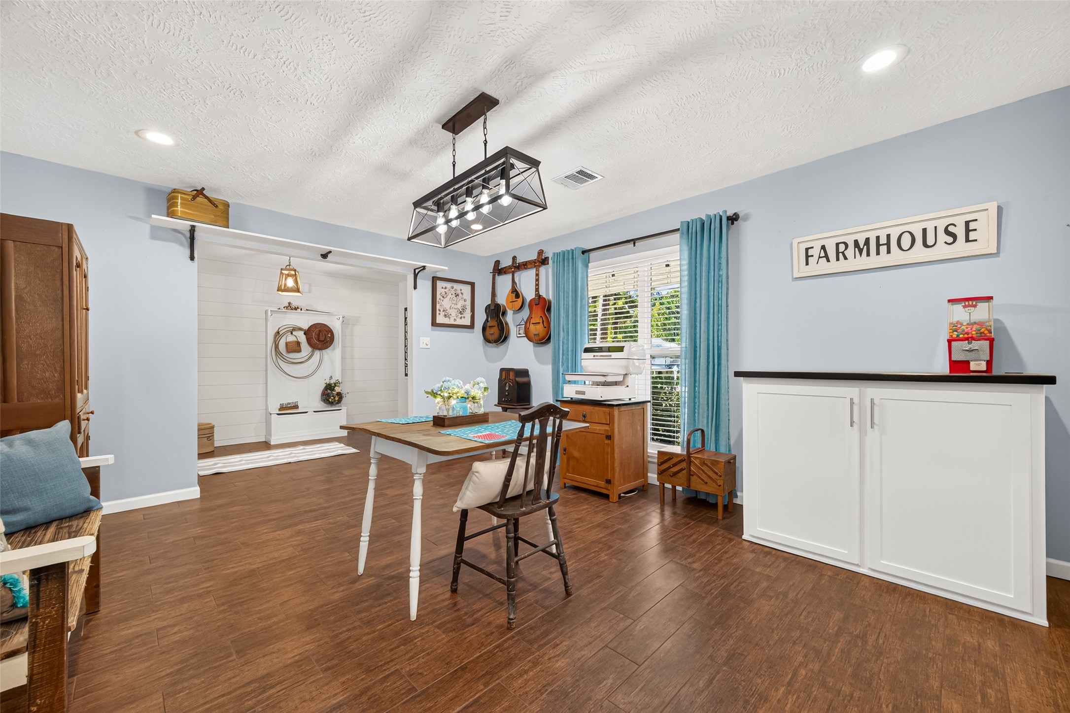 ANOTHER VIEW OF THE FORMAL DINING ROOM LOOKING TOWARDS THE FRONT ENTRYWAY WITH A LARGE WINDOW (LOW-E DOUBLE PANE) THAT LETS IN LOTS OF NATURAL LIGHT; CURTAINS AND CURTAIN ROD WILL REMAIN WITH HOME; THE WHITE CABINET WITH BROWN TOP WILL ALSO REMAIN WITH THE HOME;