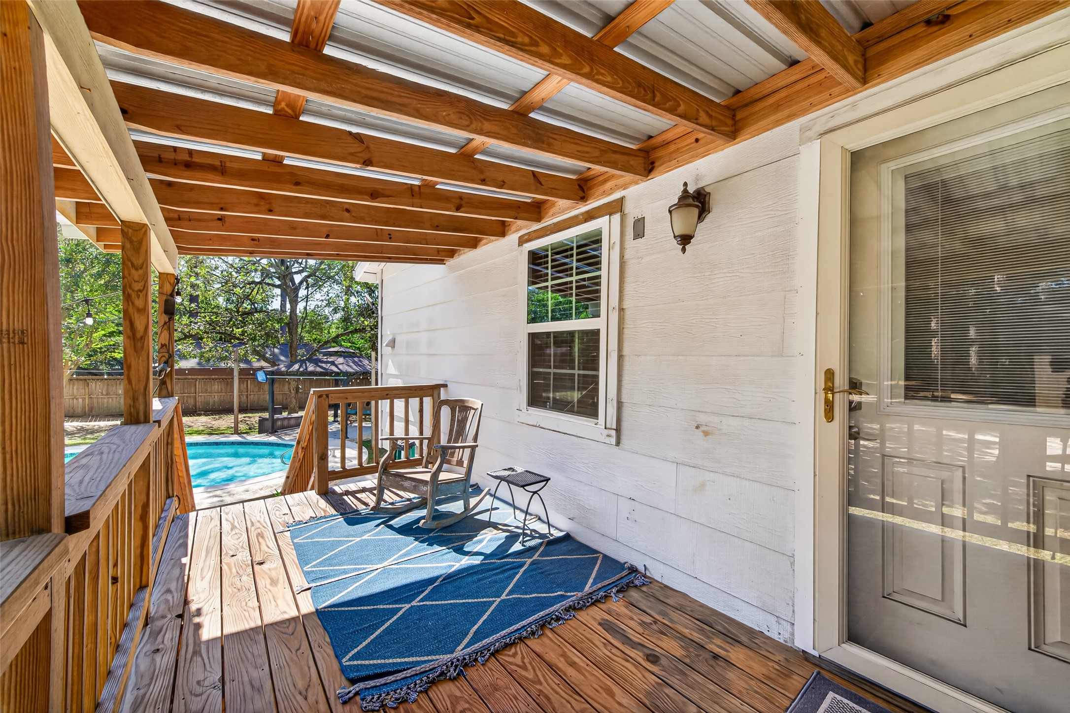 WELCOME TO THE POOL HOUSE! THIS CAN BE A GAME ROOM, MAN CAVE OR ADDITIONAL LIVING SPACE FOR FAMILY OR FRIENDS; UPDATES INCLUDE: NEW LOW-E WINDOWS, GLASS ENTRY DOOR, NEW FRONT DOOR WITH WINDOW BLIND ENCLOSURE AND A SPACIOUS COVERED PORCH WITH A METAL ROOF.