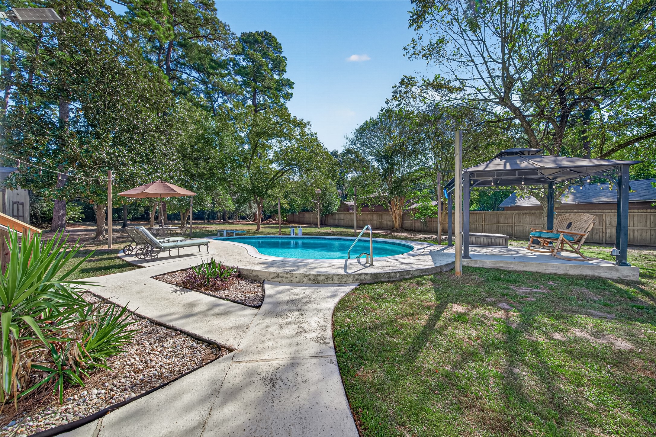 ARE YOU READY TO SPEND THE DAY AT THE POOL? AT THIS HOME, ALL YOU HAVE TO DO IS WALK OUT TO YOUR BACKYARD! CUSTOM UPGRADES INCLUDE: 10' X 10' (APPROX) CONCRETE PAD AND ATTACHED GAZEBO W/GFCI OUTLETS, CEILING FAN AND LIGHTS. ALL HANGING LIGHTS WILL REMAIN WITH HOME. TWO (2) LOUNGE CHAIRS W/CUSHIONS WILL REMAIN WITH HOME. (EXCLUSIONS: PATIO SET W/ UMBRELLA)