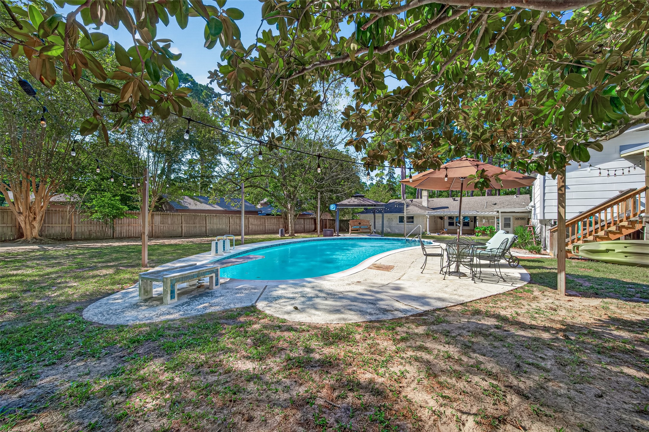 ANOTHER VIEW OF THE BEAUTIFUL BACKYARD, POOL AND ENTRY TO THE POOL HOUSE! THIS BACKYARD OFFERS SO MUCH SPACE TO ENTERTAIN FAMILY AND FRIENDS. THE POOL IS 9FT DEEP.