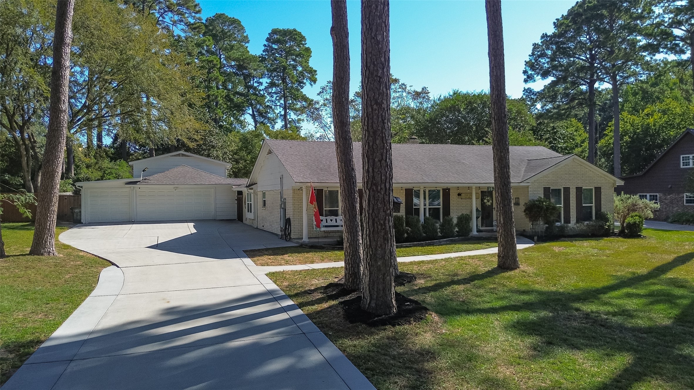 THREE (3) CAR GARAGE WITH AUTOMATIC GARAGE DOOR OPENERS; AS WELL AS THE SINGLE BAY DRIVES ALL THE WAY THROUGH TO A COVERED CARPORT