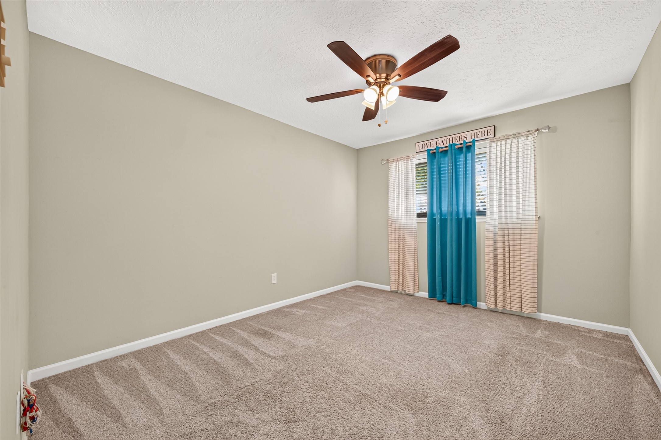 ONE (1) OF THREE SECONDARY SPACIOUS GUEST BEDROOMS HAS A WALK IN CLOSET. THE LARGE WINDOW OFFERS A TON OF NATURAL LIGHT. THE CARPET THROUGHOUT THE HOME AS BEEN PROFESSIONALLY CLEANED. CURTAIN/CURTAIN ROD WILL REMAIN WITH HOME.