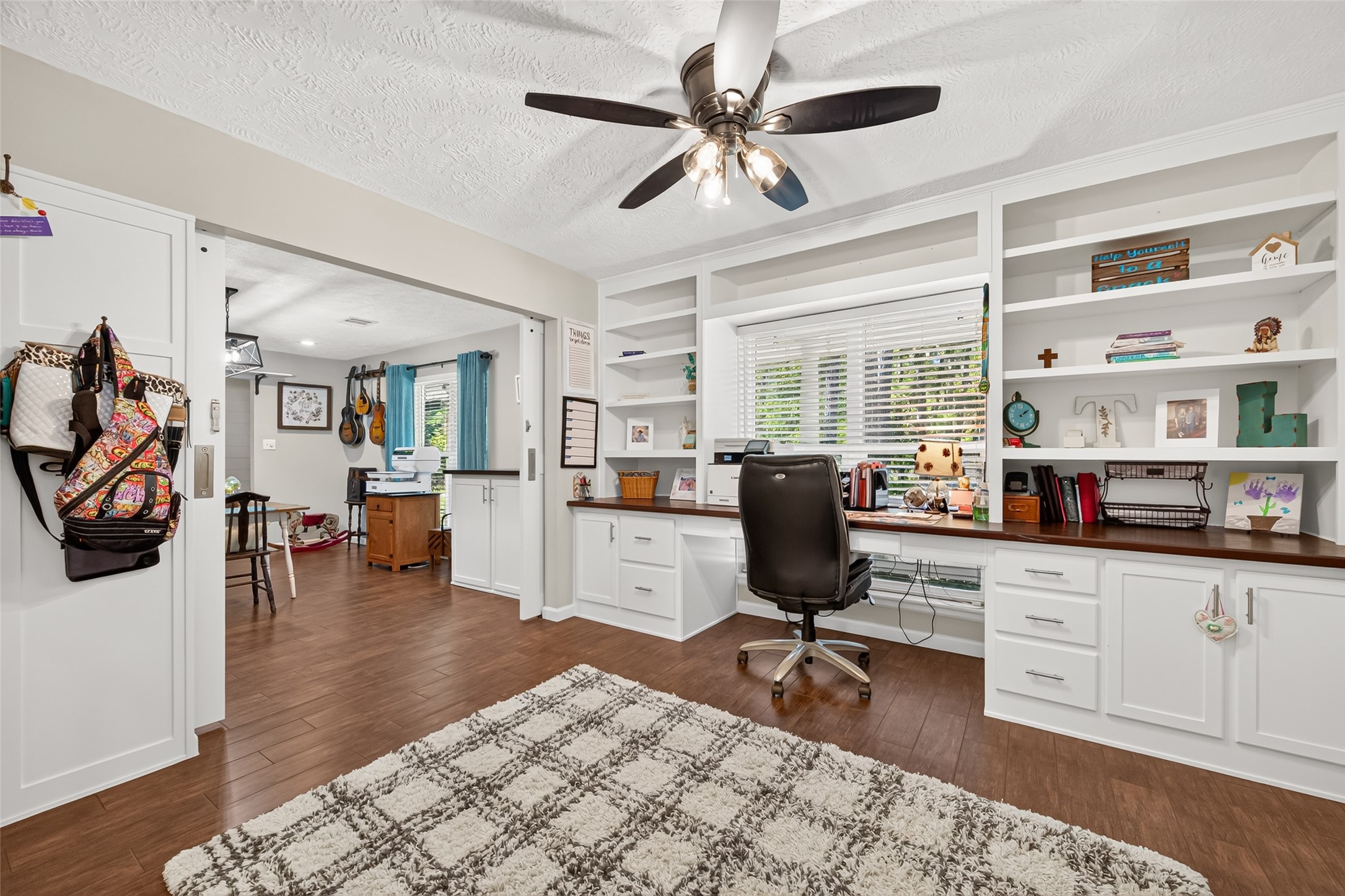 WOW! DO YOU WORK FROM HOME? THIS WAS A DINING ROOM THAT WAS TURNED INTO AN OFFICE; ALL CUSTOM BUILT SHELVES, DESK, SLOW CLOSING CABINET DOORS, (2) BUILT-IN FILING CABINETS; LOTS OF CABINET AND SHELF SPACE; CLOSE THE DOUBLE BARN DOORS FOR MORE PRIVACY; LOTS OF NATURAL LIGHT
