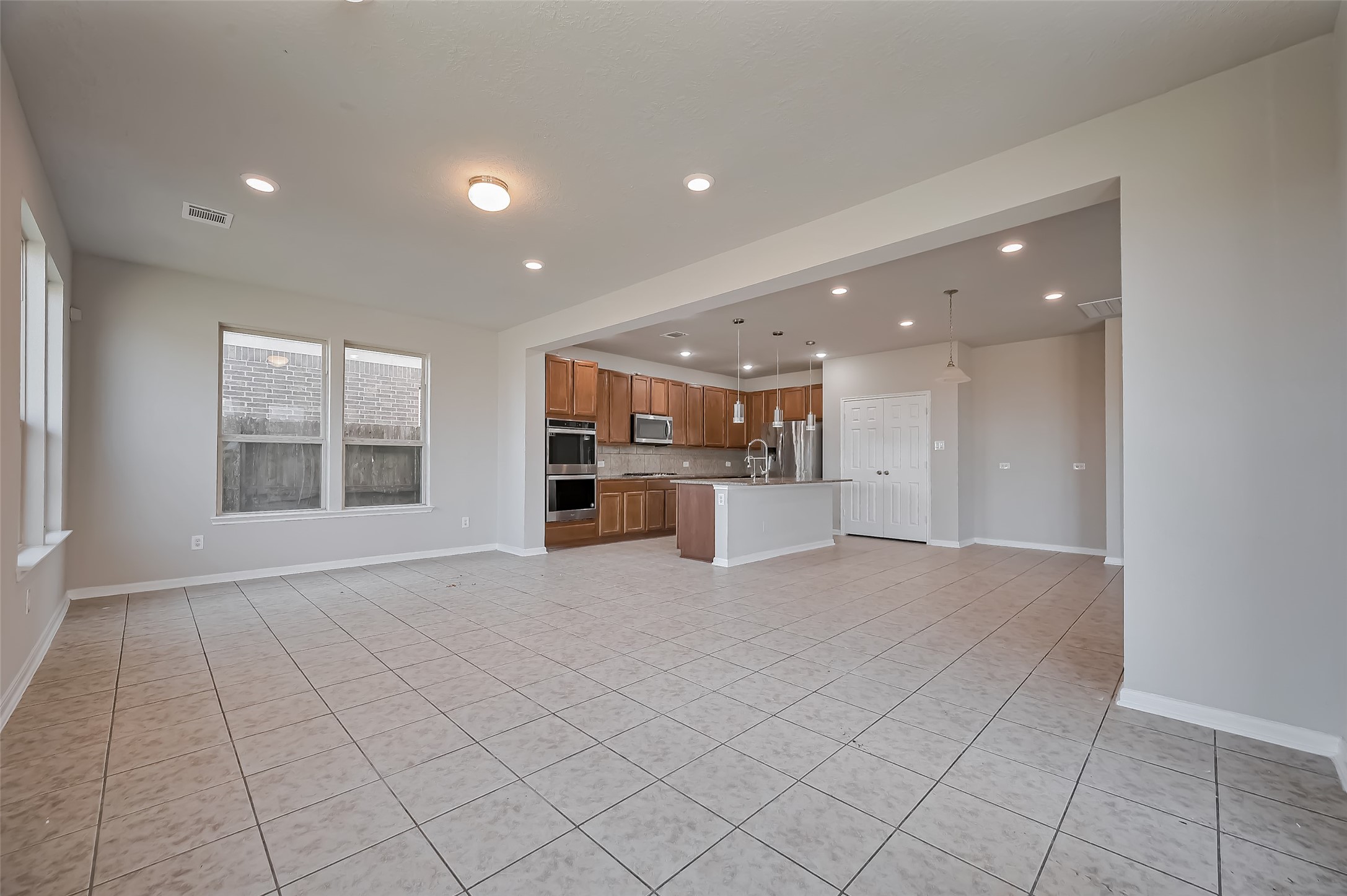 Family room with a sleek kitchen design.