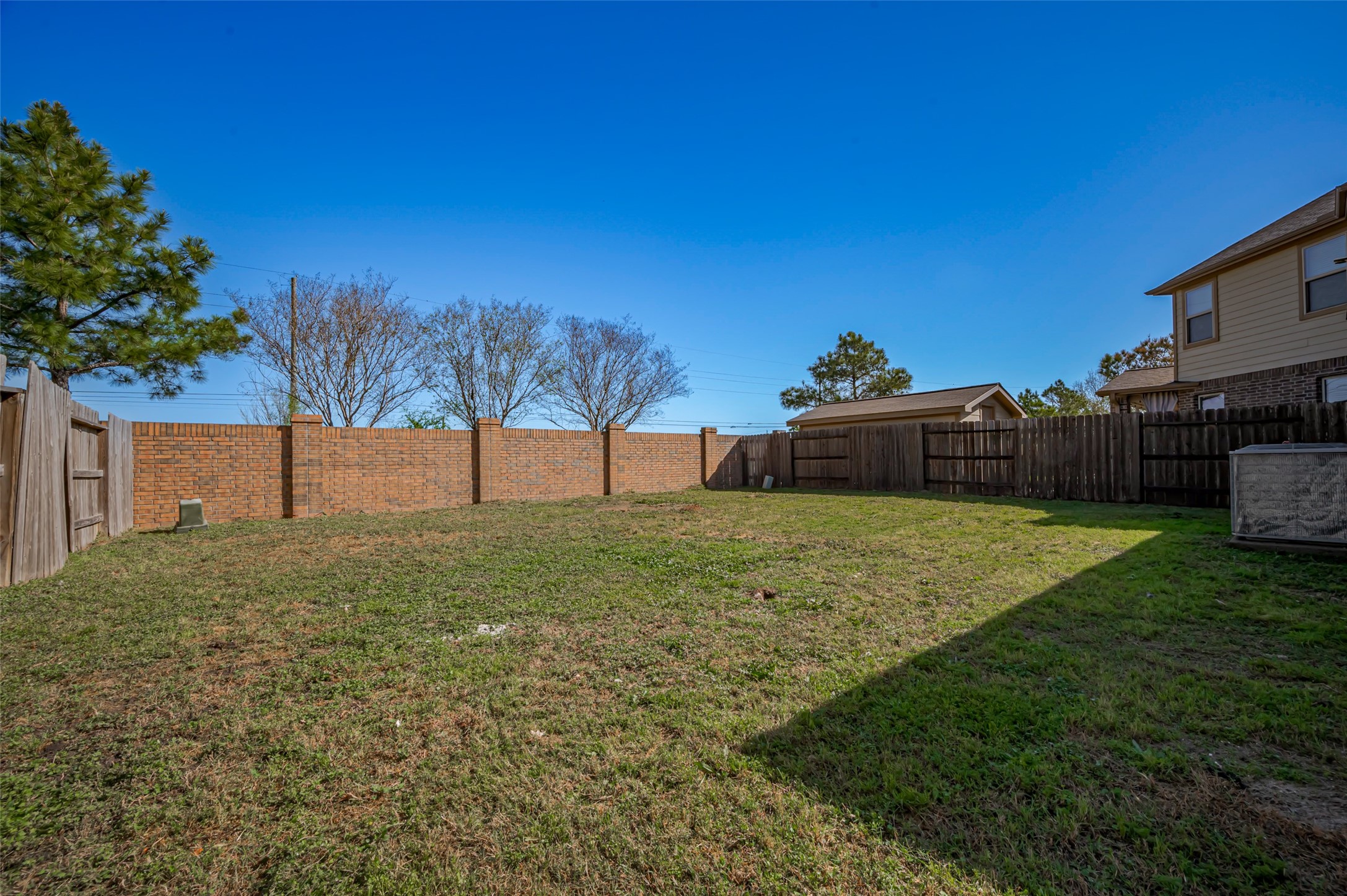 Fenced backyard with a well maintained lawn.