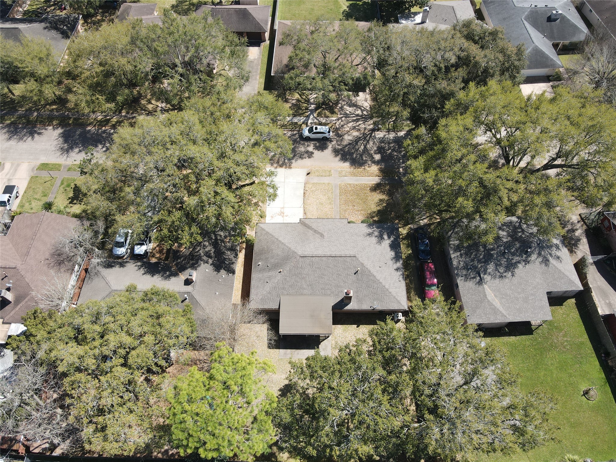 Nestled in a charming neighborhood, this home boasts a spacious backyard perfect for outdoor living, surrounded by mature trees offering privacy and tranquility.