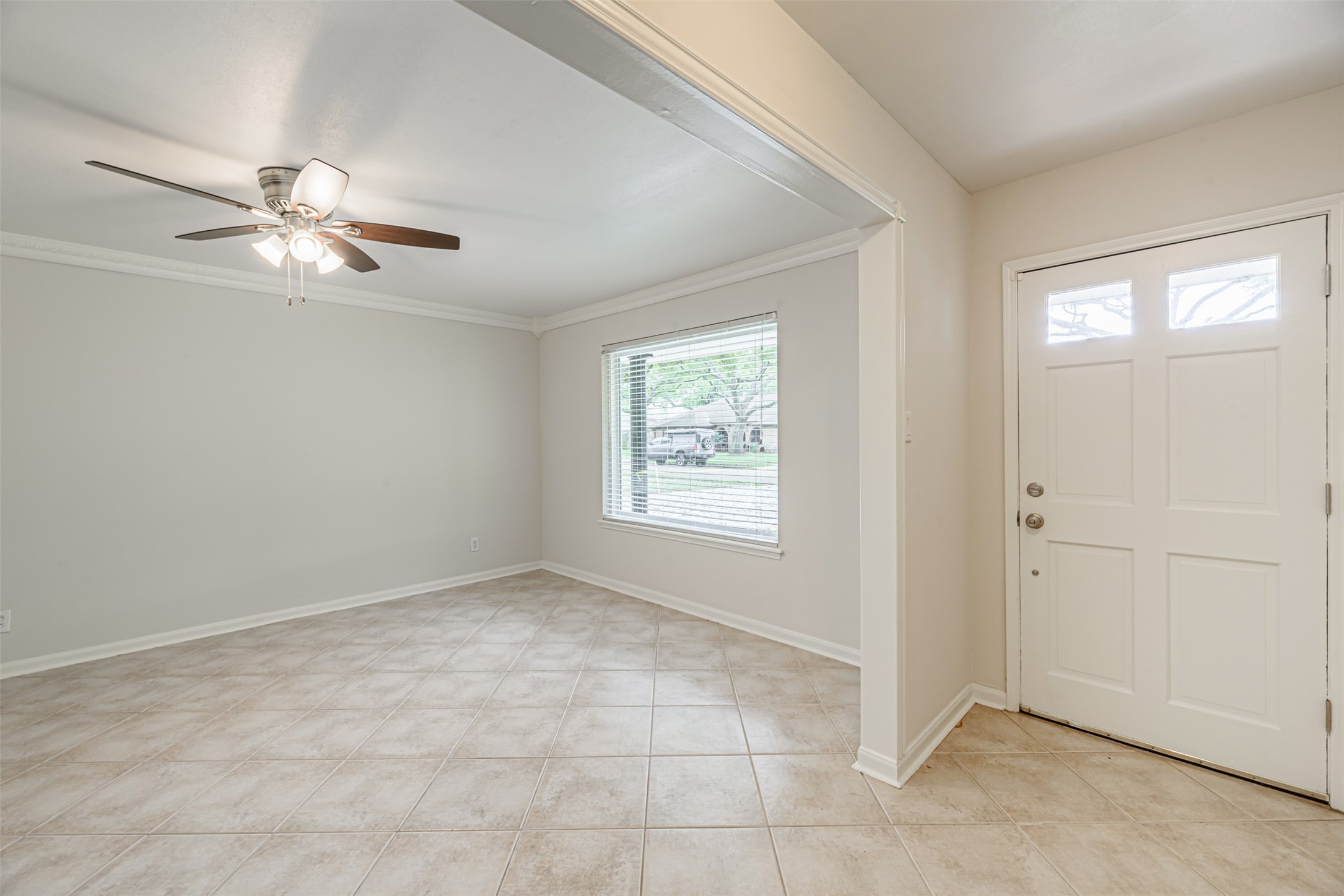 Formal living room. The window provides natural light and view of the street. On the right the main door that gives access to the house.