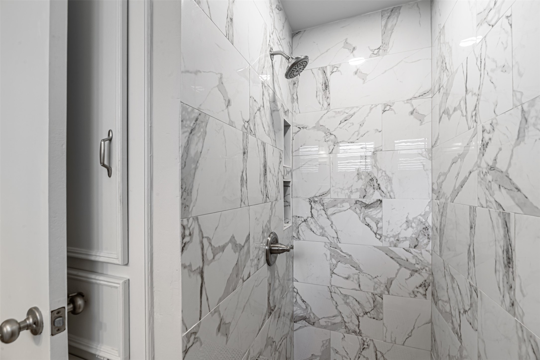 Beautifully remodeled bathroom walls, plus plenty of cabinets to keep you organized.