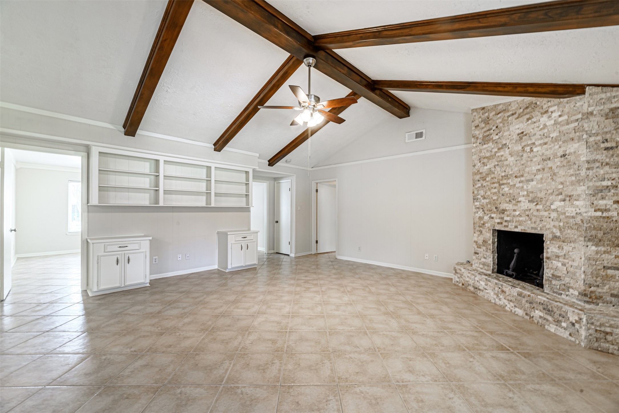 The living room's stunning stone fireplace creates a cozy and inviting atmosphere, perfect for relaxation.