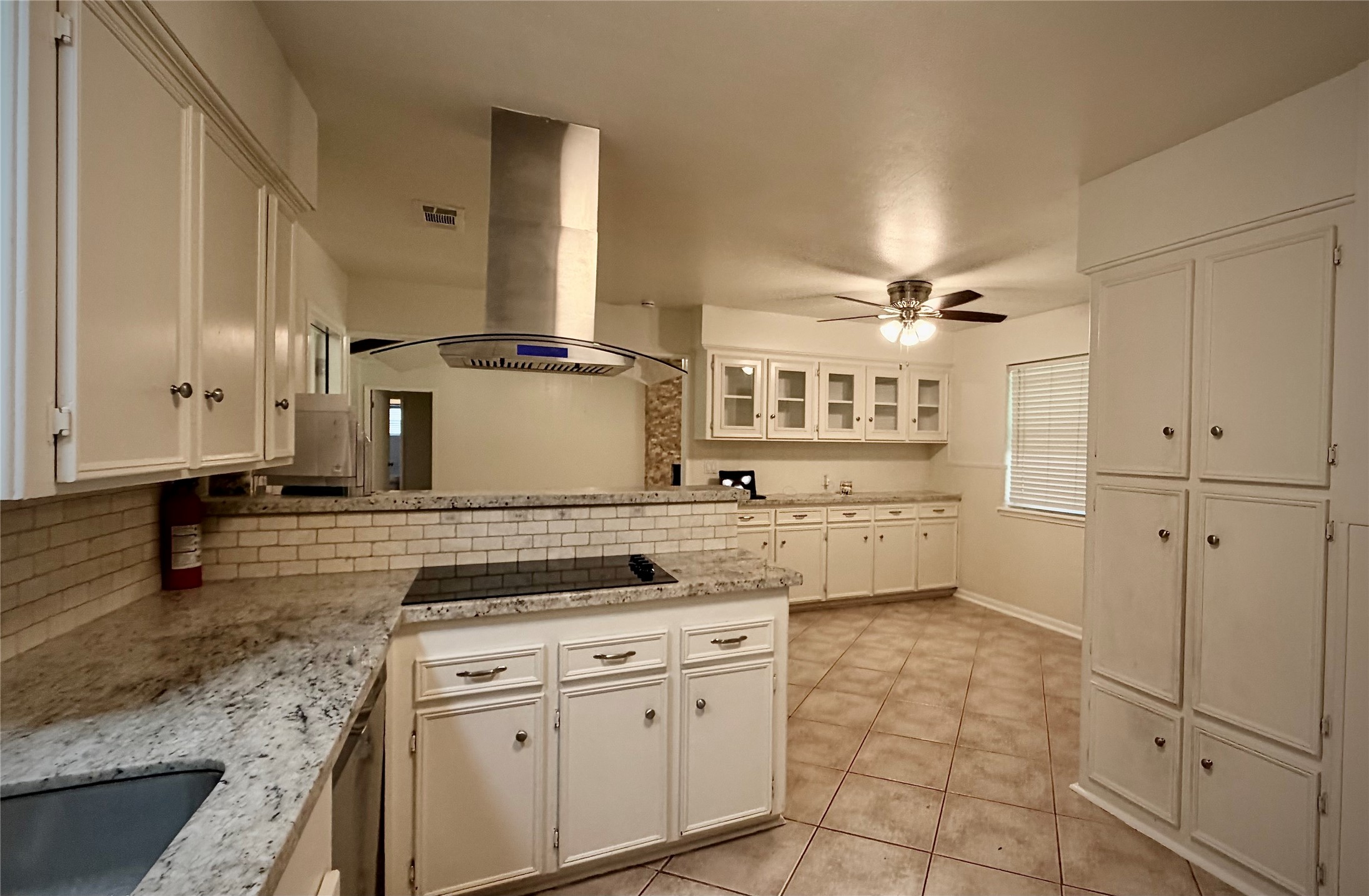 Expansive kitchen seamlessly connects to a bright breakfast nook, ideal for casual dining and entertaining.