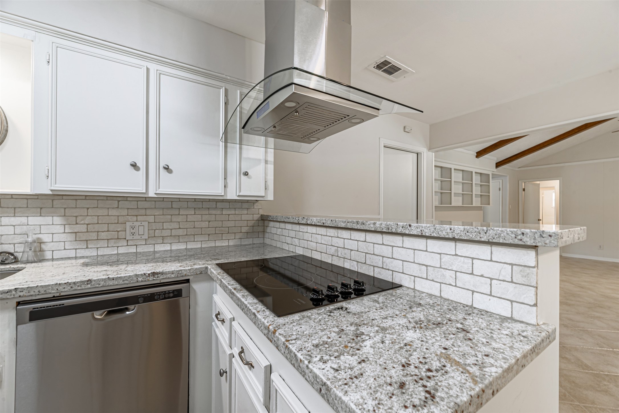 Sleek stainless steel appliances and elegant granite countertops create a modern and inviting kitchen space.