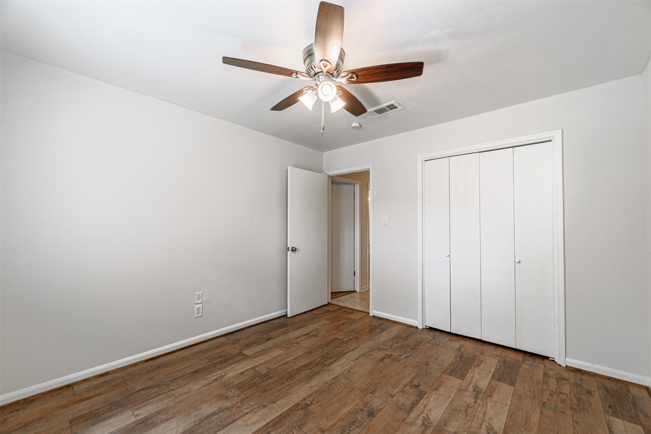 The 3rd bedroom, with a good size closet and beautiful floors.