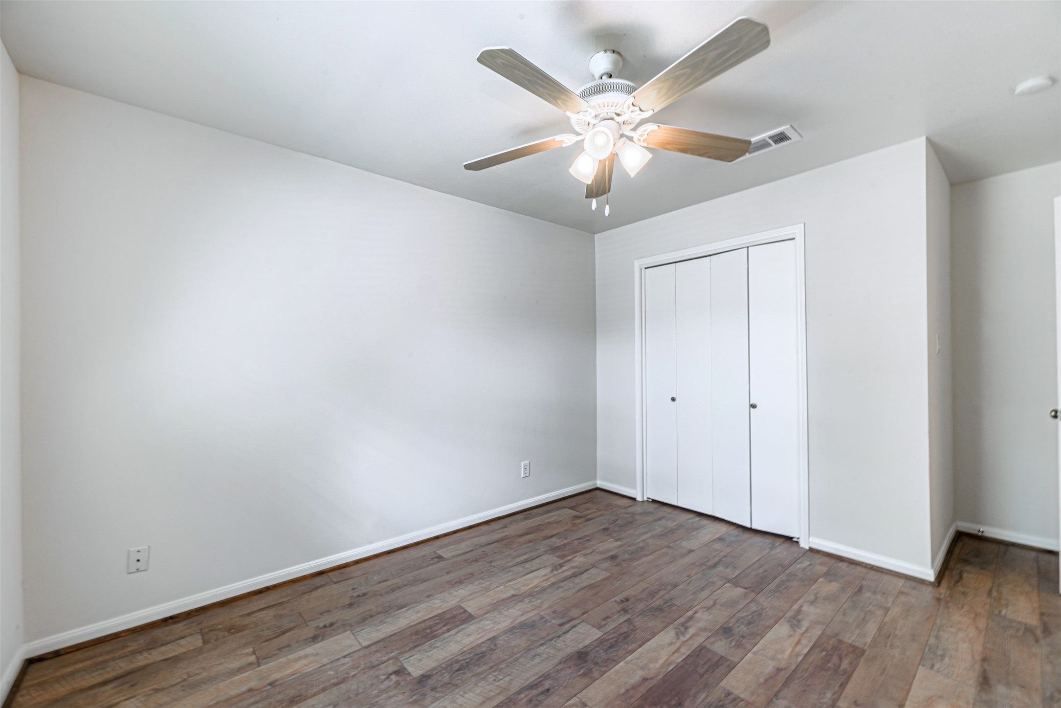 The third bedroom, with comfortable closets, beautiful floors and newly installed fans.