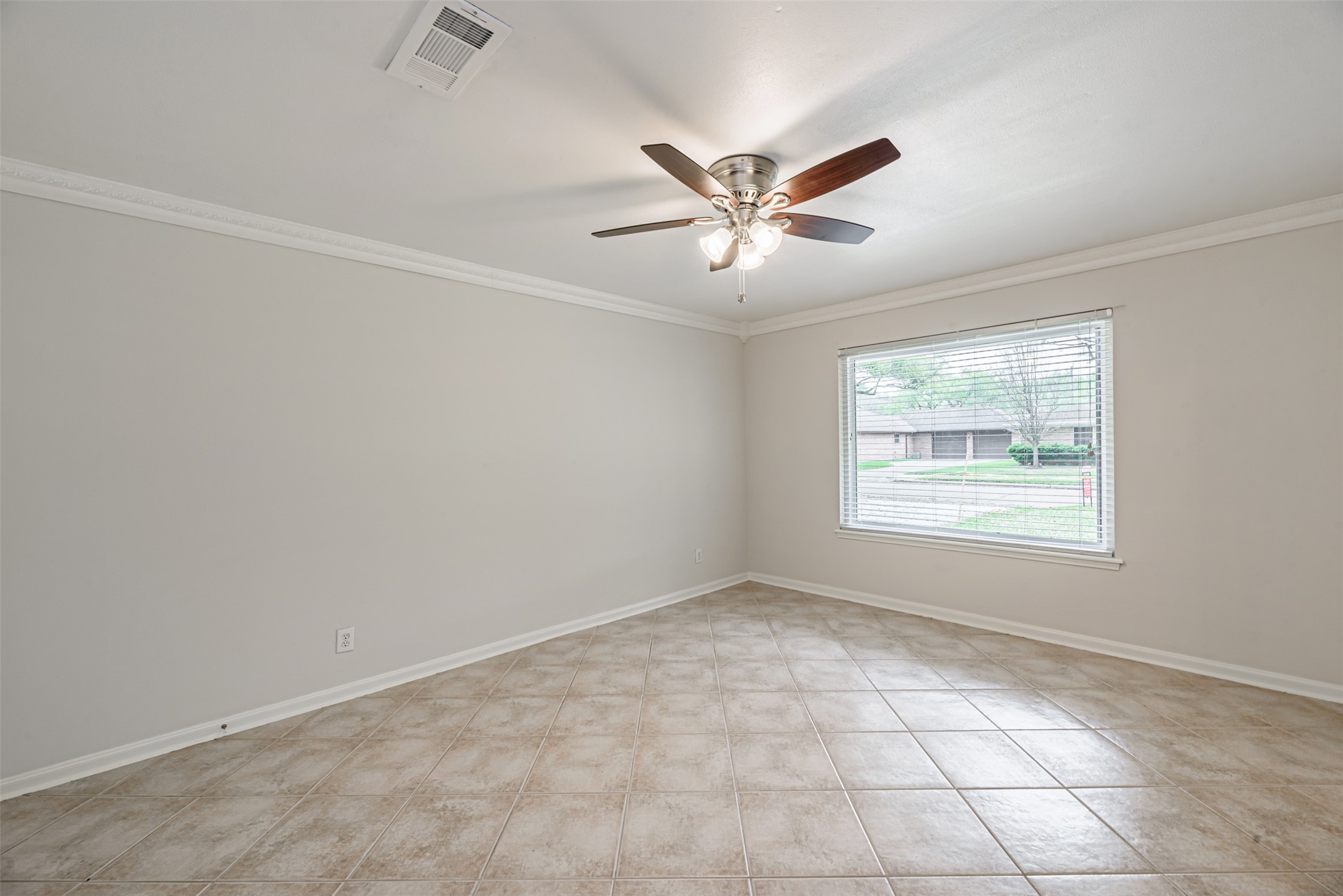 Abundant natural light floods this versatile space, perfect as a formal living area or easily transformed into a bright study.