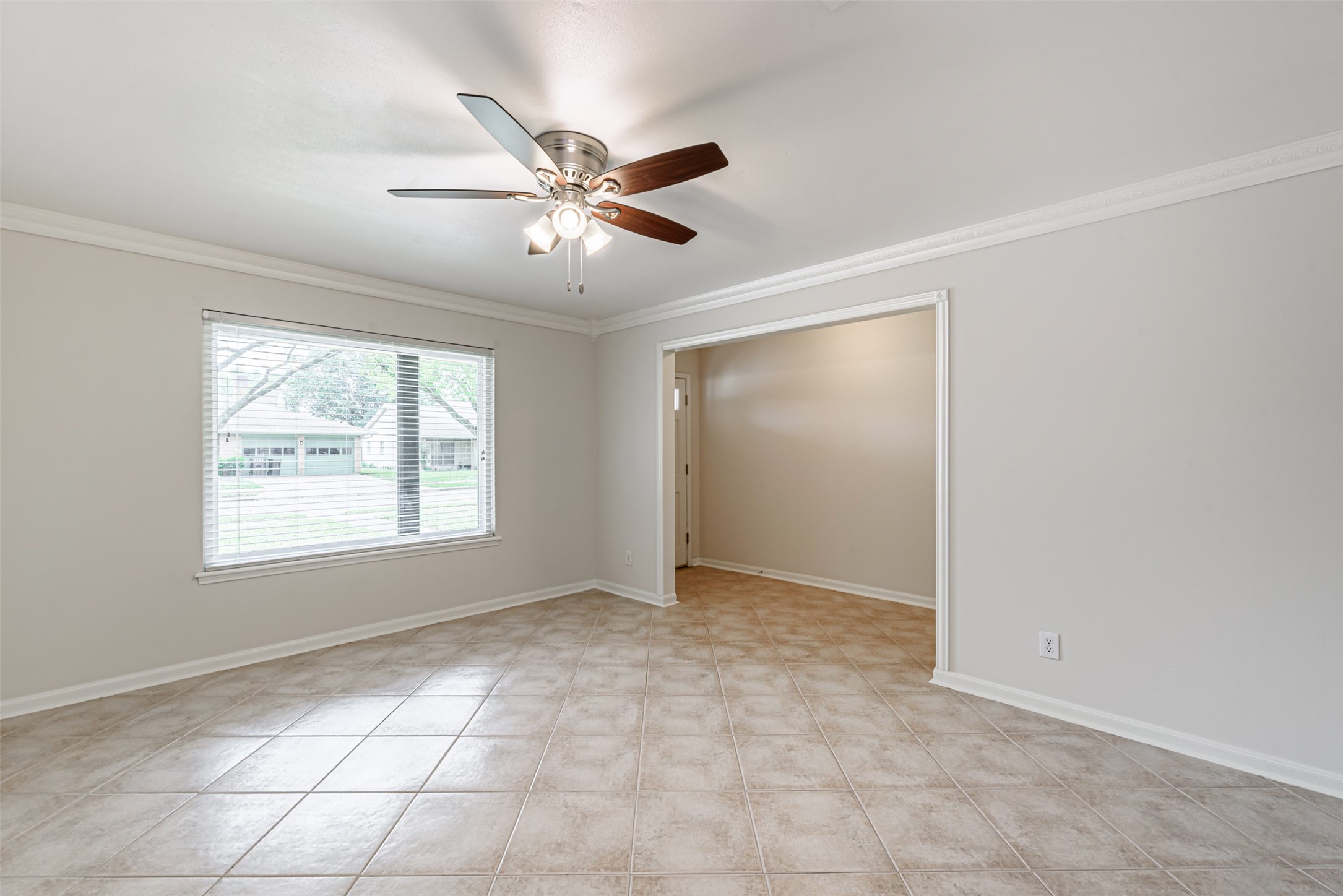 Elegant open-plan view from the family room to the formal living area, seamlessly guiding you through the hallway to the inviting main entrance.
