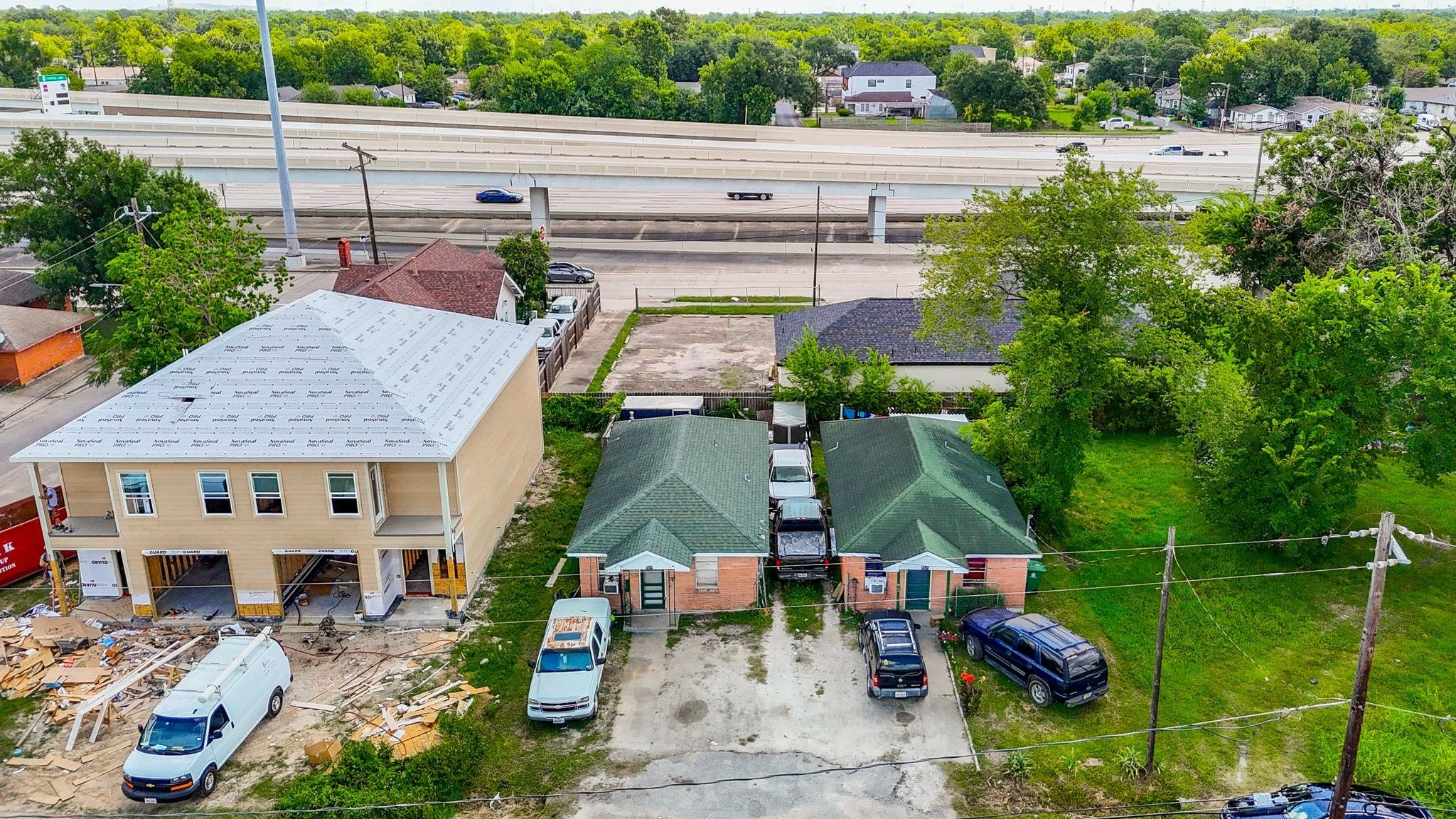 Two units with long term tenants surrounded by new construction.