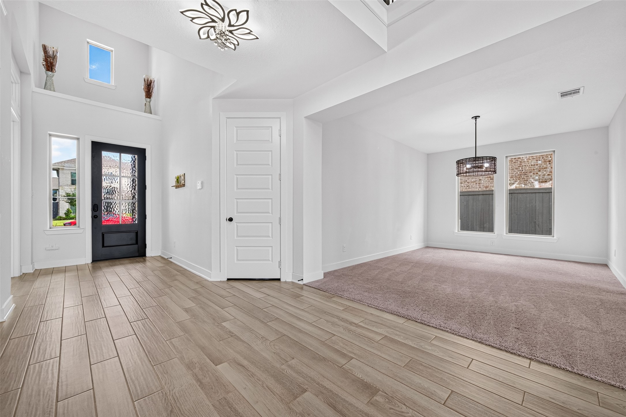 An elegant grand entry welcomes you with an abundance of natural light streaming through the front entrance, creating a striking first impression of luxury, warmth, and timeless sophistication