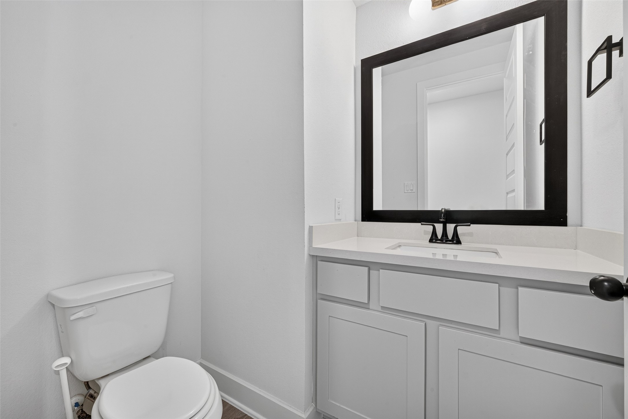 A conveniently located first-floor powder room featuring a polished, inviting design that adds a touch of elegance and comfort for guests and everyday living