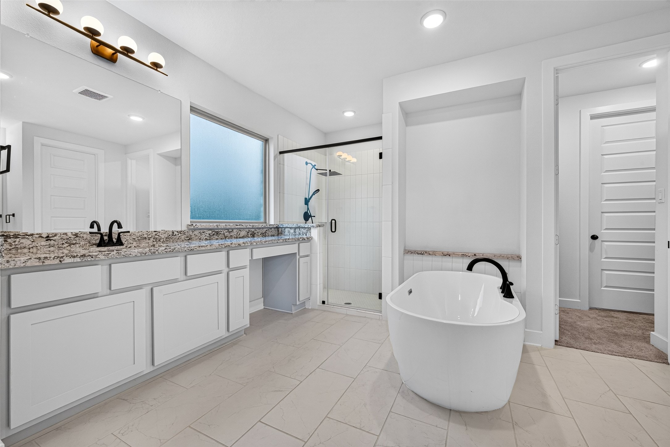 An opulent primary bathroom designed to evoke a five-star spa experience, featuring sophisticated double vanities, an expansive glass-enclosed walk-in shower, and a luxurious freestanding soaking tub, creating an exquisite retreat for relaxation and indulgence