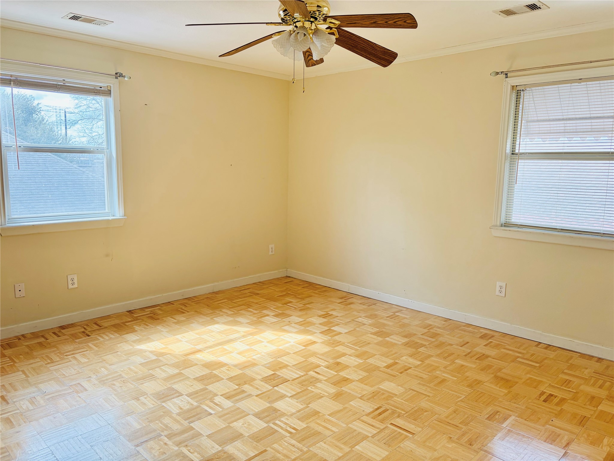 Large bedroom with walk-in closet, plenty of natural light and ceiling fan