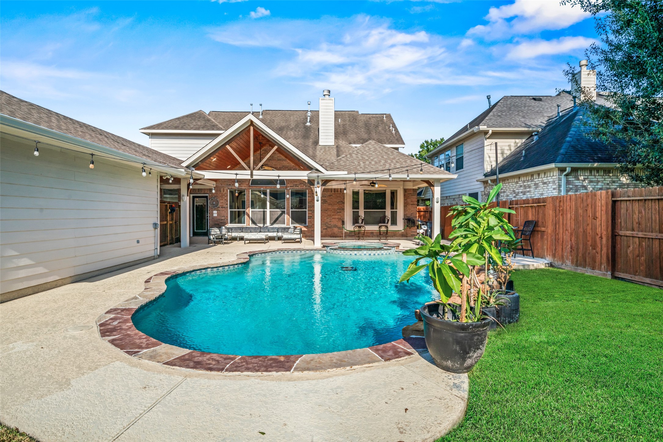 Landscaping adds a welcoming touch to this backyard retreat!
