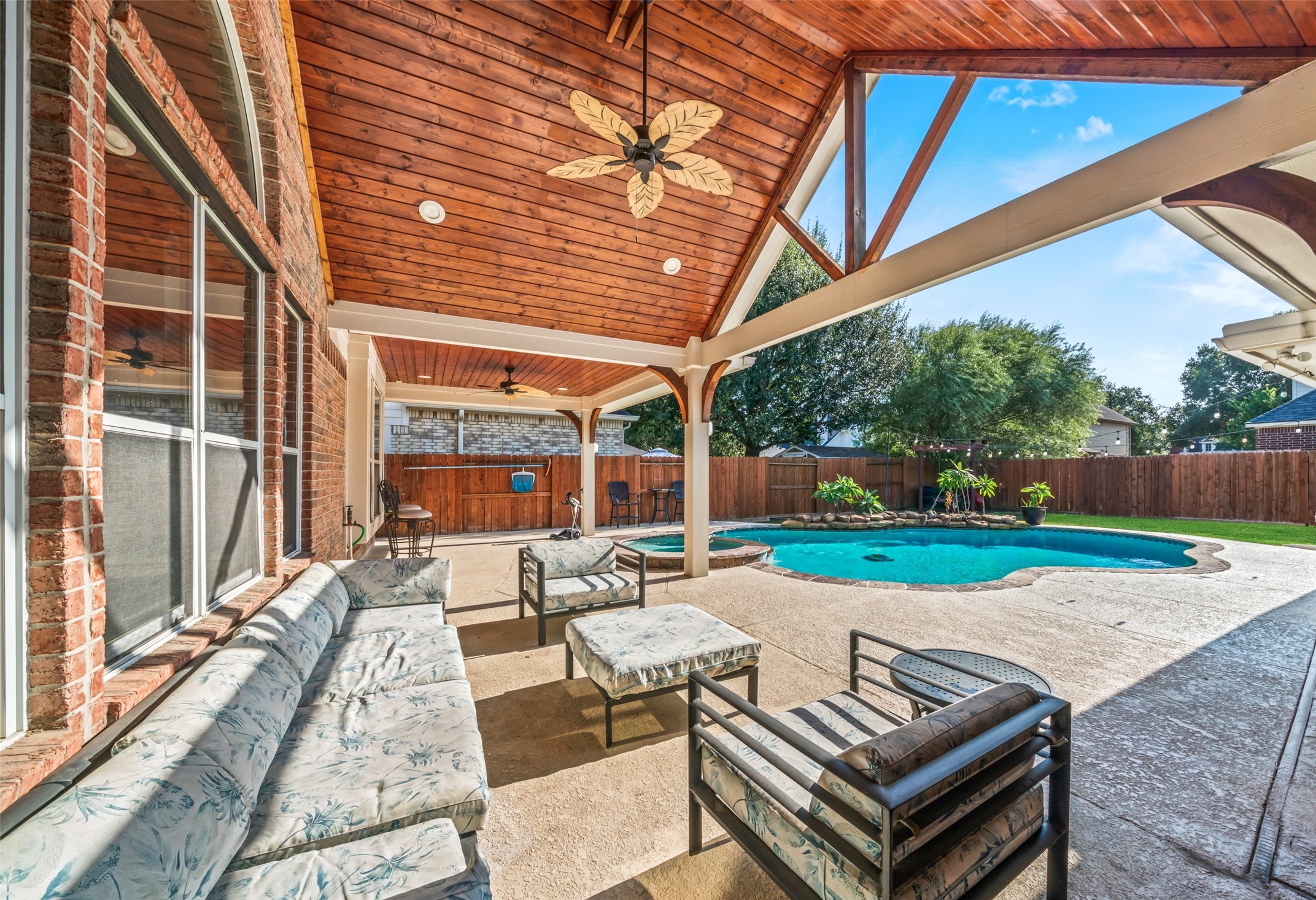 Beautiful vaulted wood-paneled ceilings add warmth and character to this inviting outdoor space.