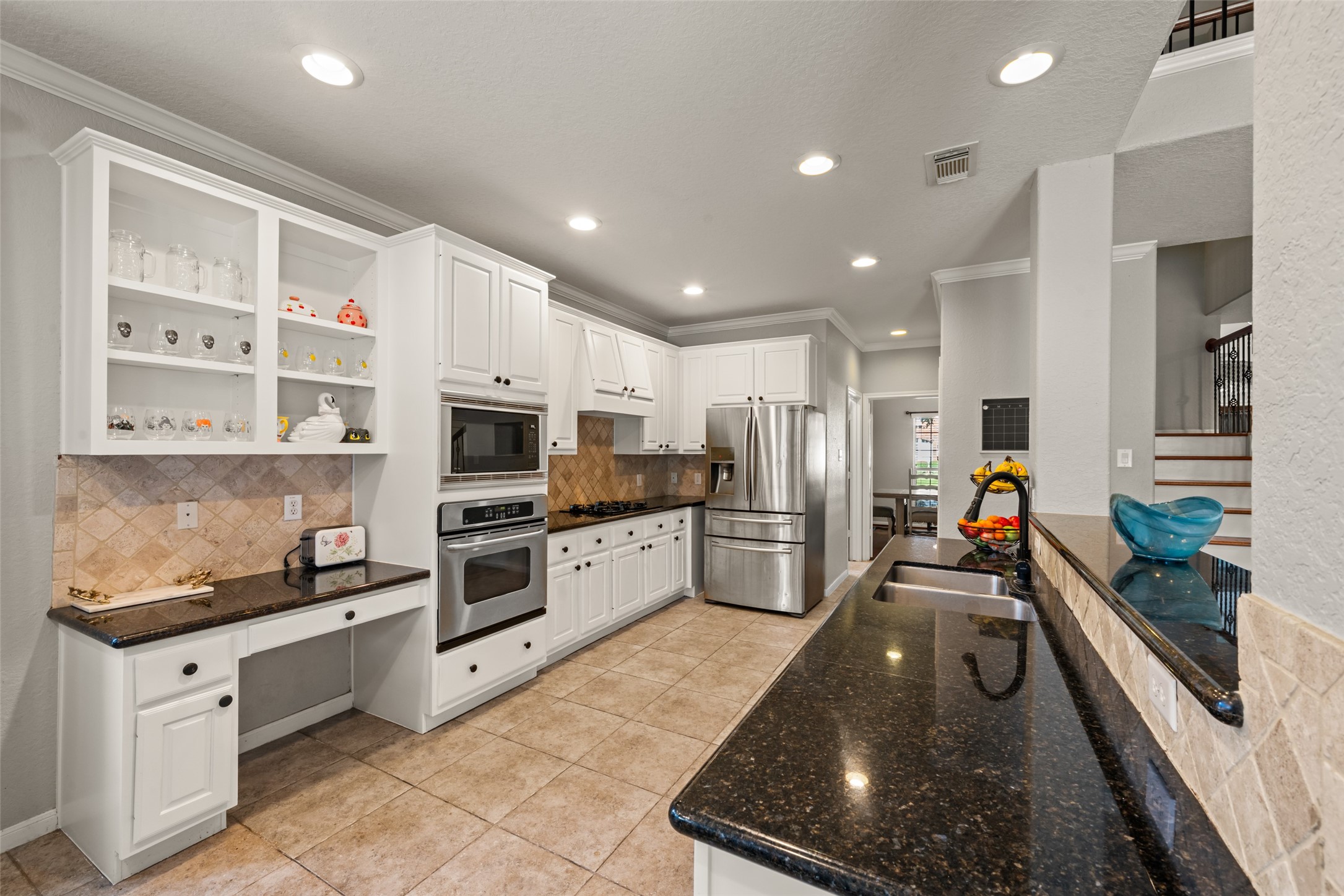The well-designed kitchen includes stainless steel appliances and a dedicated workspace.
