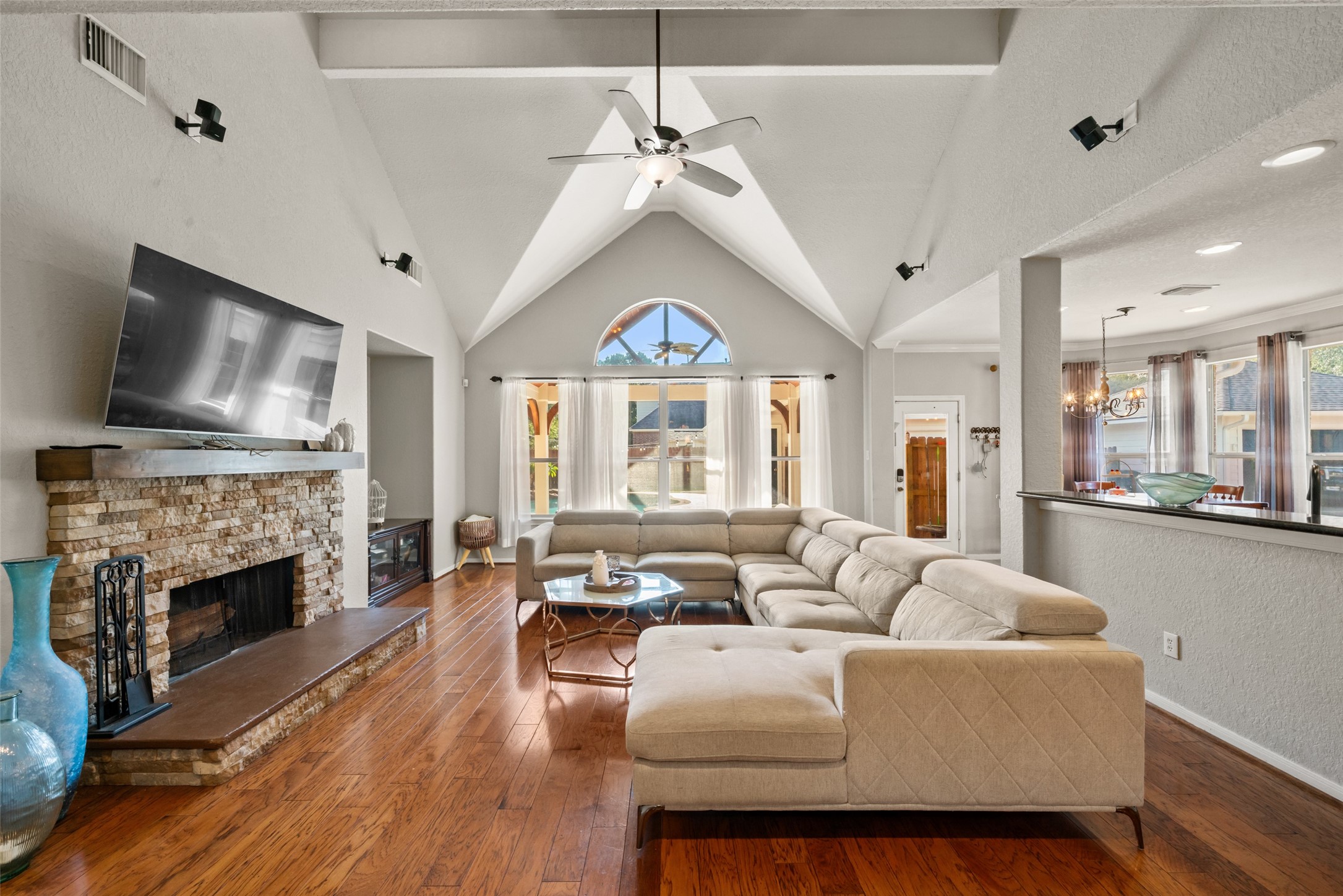 Inside, the soaring cathedral ceilings are flooded with natural light, creating an impressive living area.
