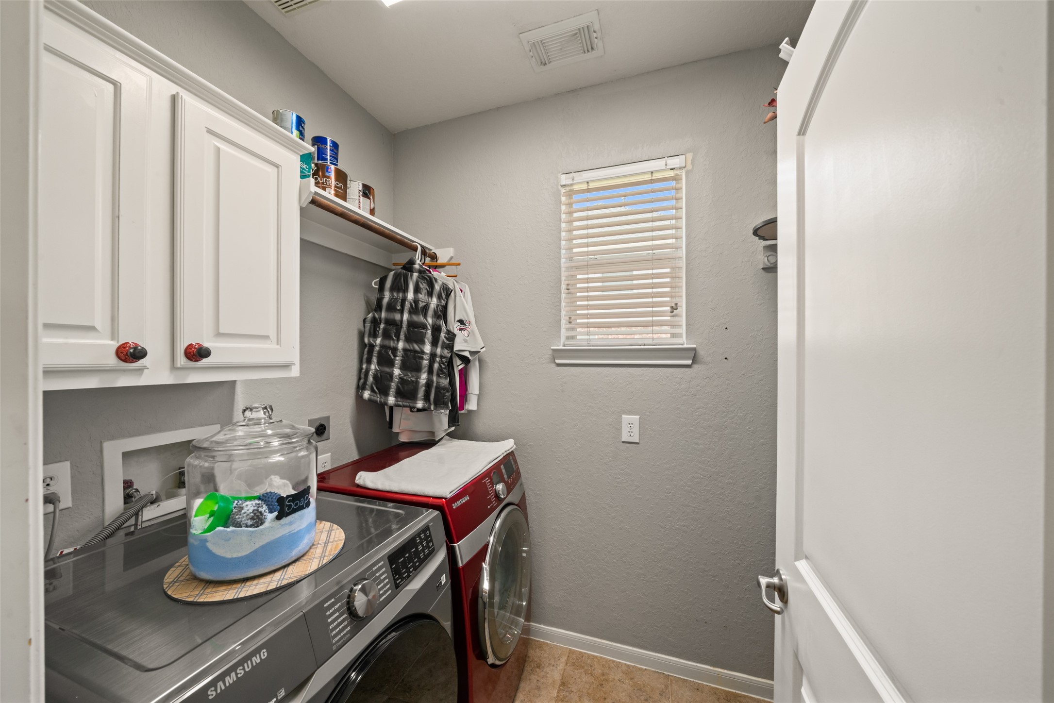 The dedicated laundry room has plenty of storage.