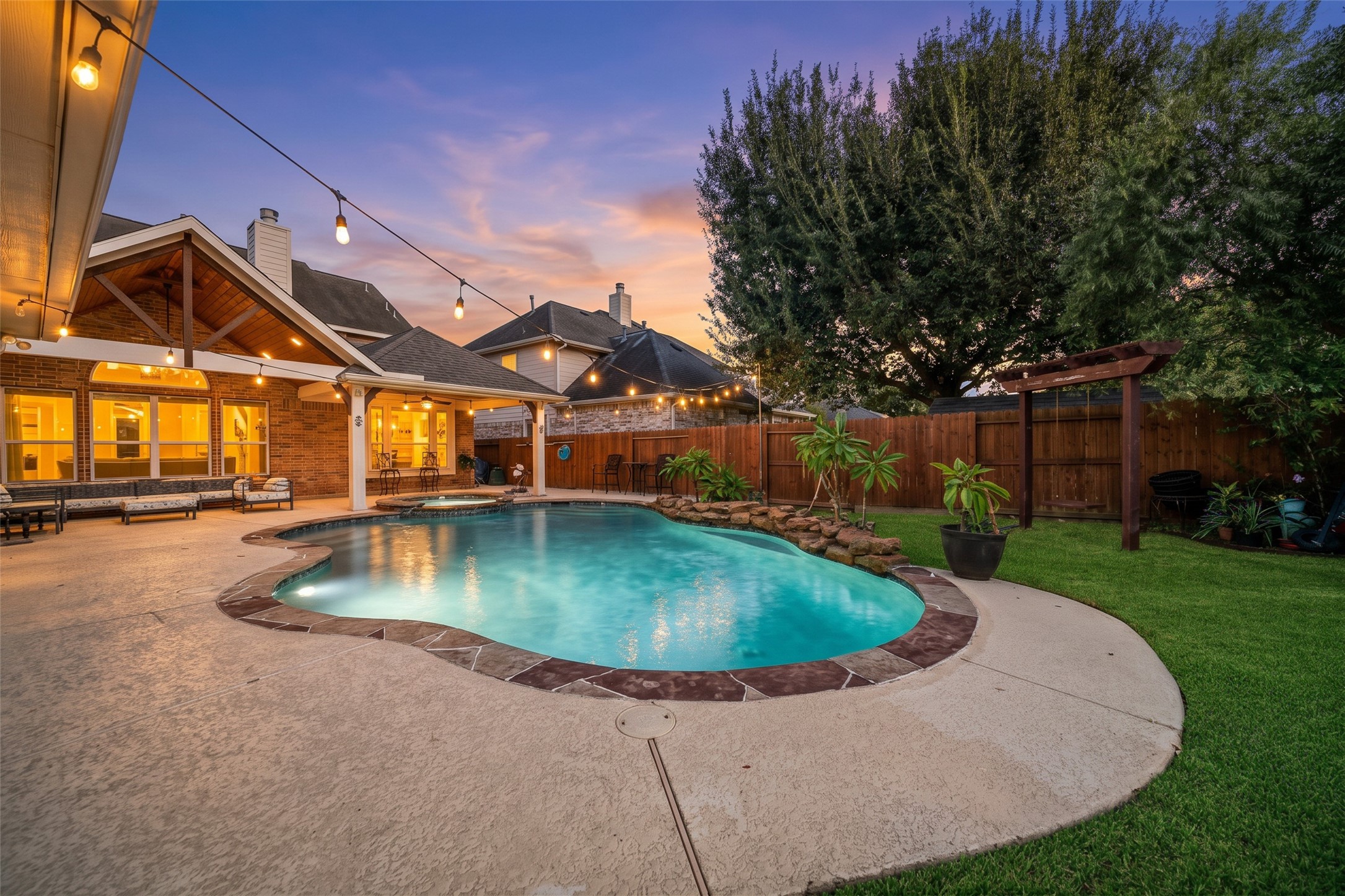 Your backyard oasis comes alive as the sun goes down! And there is even a swing to relax and enjoy the view.