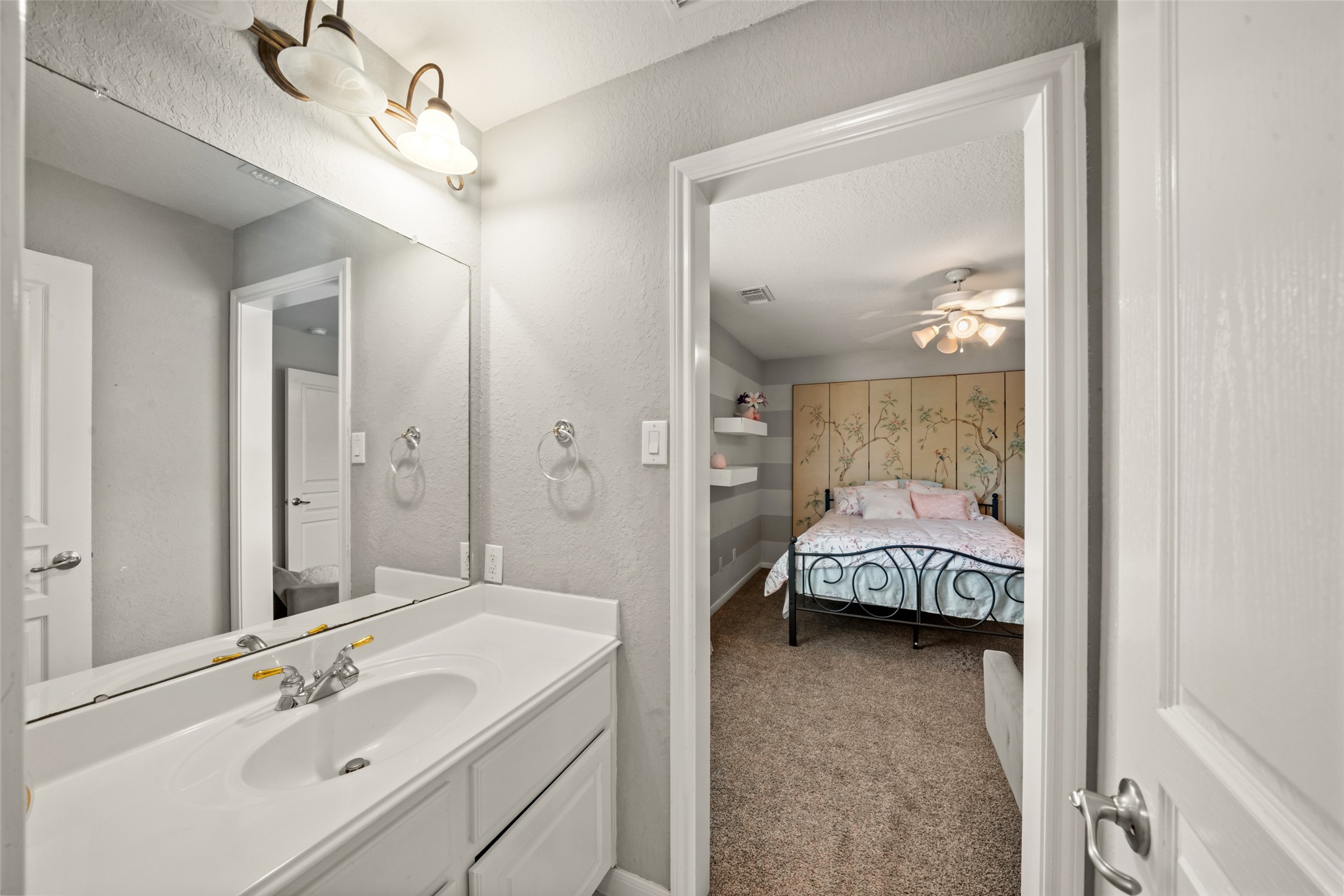 The vanity by the other bedroom of this shared bathroom offers everyday convenience!