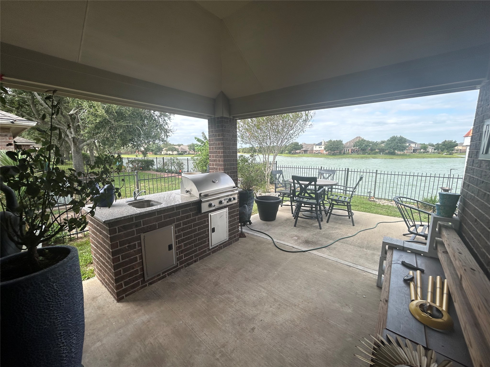 Covered patio equipped with gas grill & sink