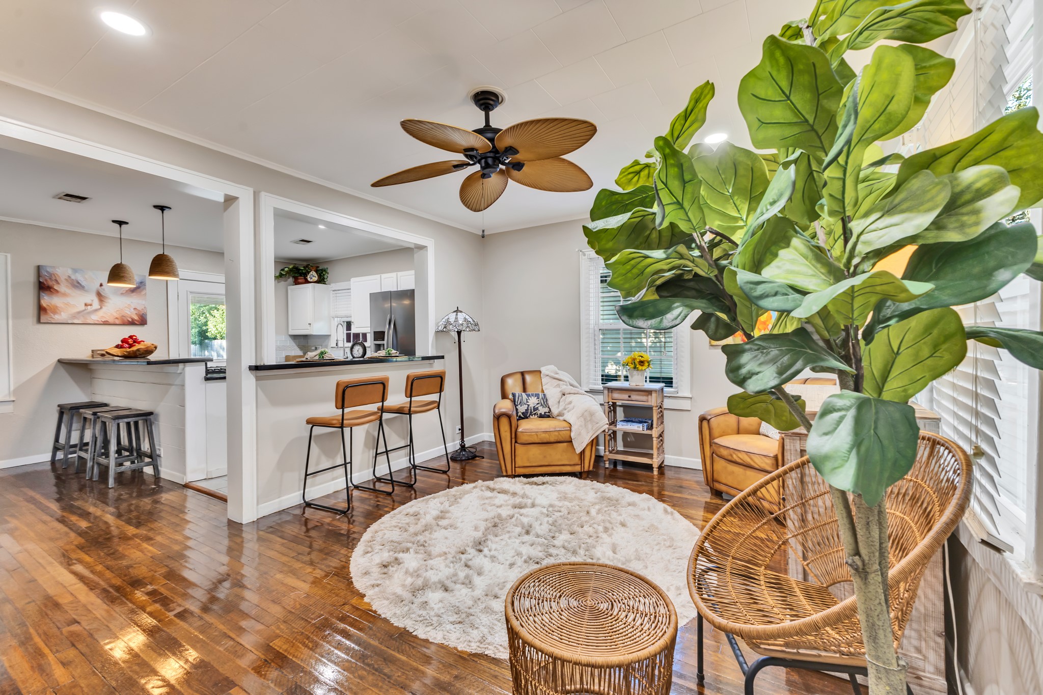 Beautiful wood flooring adds warmth and character to this inviting living room. Its connection to the kitchen creates a practical layout that makes everyday living and entertaining feel effortless.