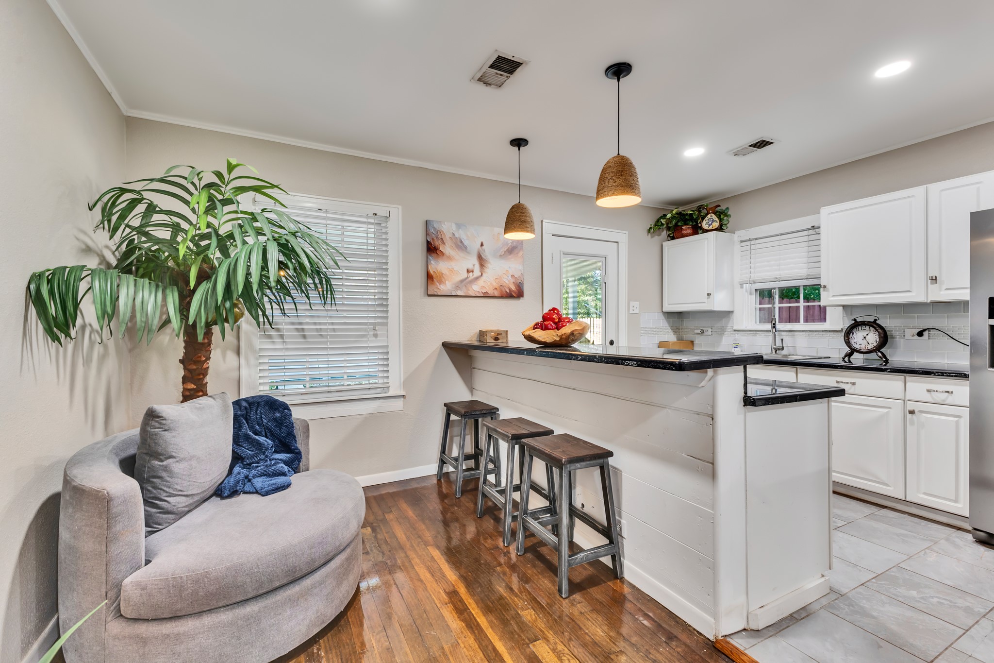The breakfast bar adds more than visual appeal! It provides a convenient spot for casual dining, morning coffee, or extra seating when entertaining, making the most of the home's layout.