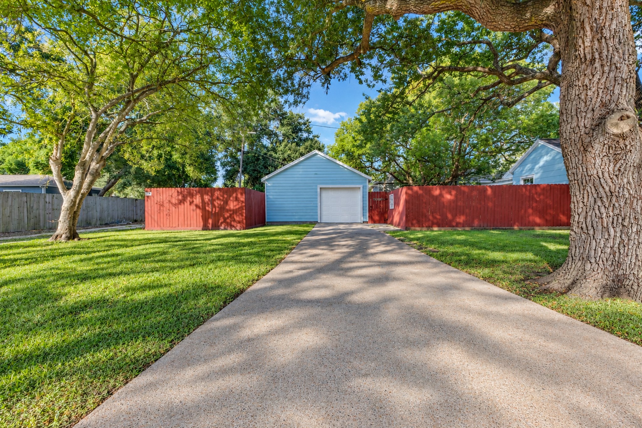 A long driveway provides convenient access to the detached garage, while mature trees and open lawn add to the property's character. These outdoor features offer everyday practicality that can be difficult to find in smaller homes.