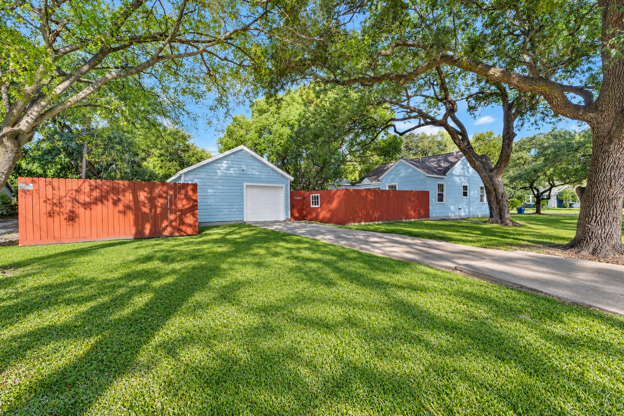 A detached garage and long driveway add practical appeal beyond the home's interior. Enjoy dedicated space for vehicle parking and the convenience of a driveway extending toward the rear of the property.