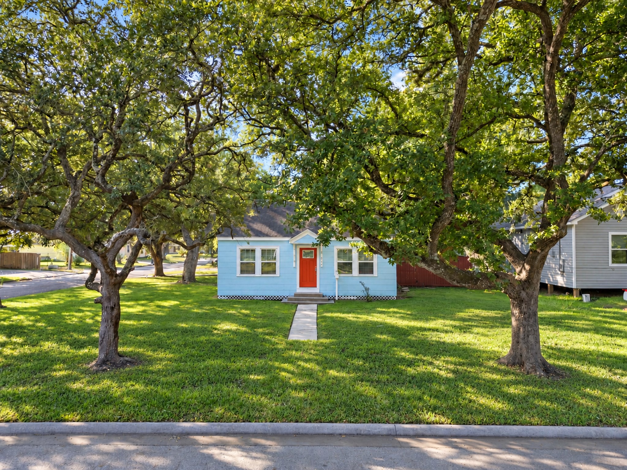 The mature trees and expansive front lawn create a welcoming approach to this Galveston home. Enjoy the visual appeal of established landscaping and the opportunity to make this charming home your own.