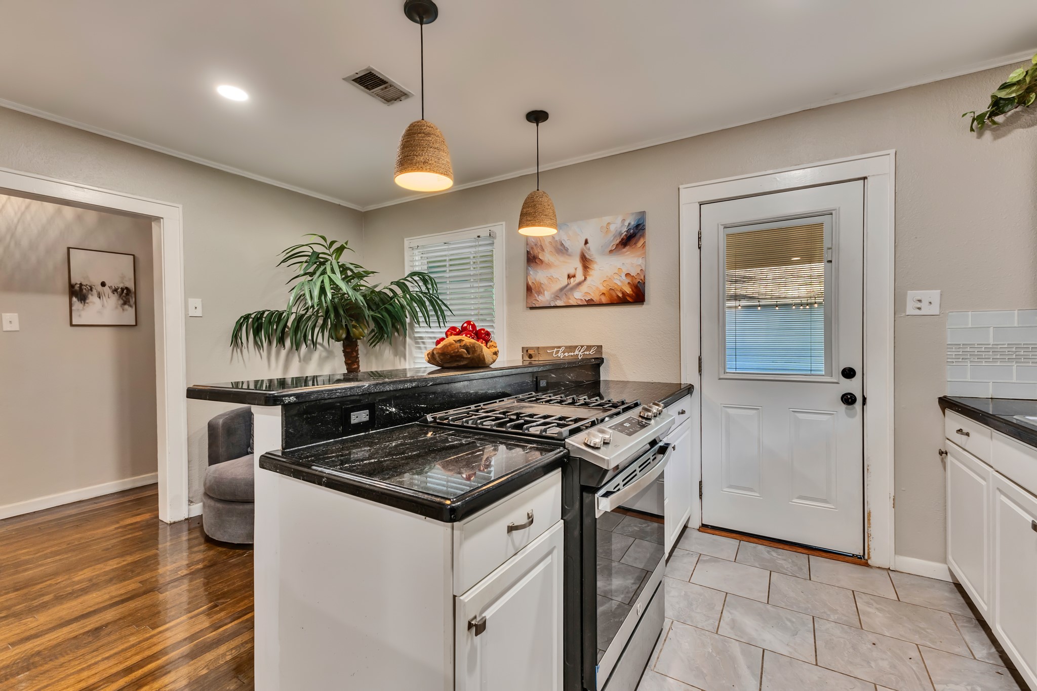 Convenient access from the kitchen to the outdoor area adds flexibility for everyday living. Whether carrying groceries, stepping outside for fresh air, or enjoying outdoor gatherings, this layout makes moving between spaces easy.