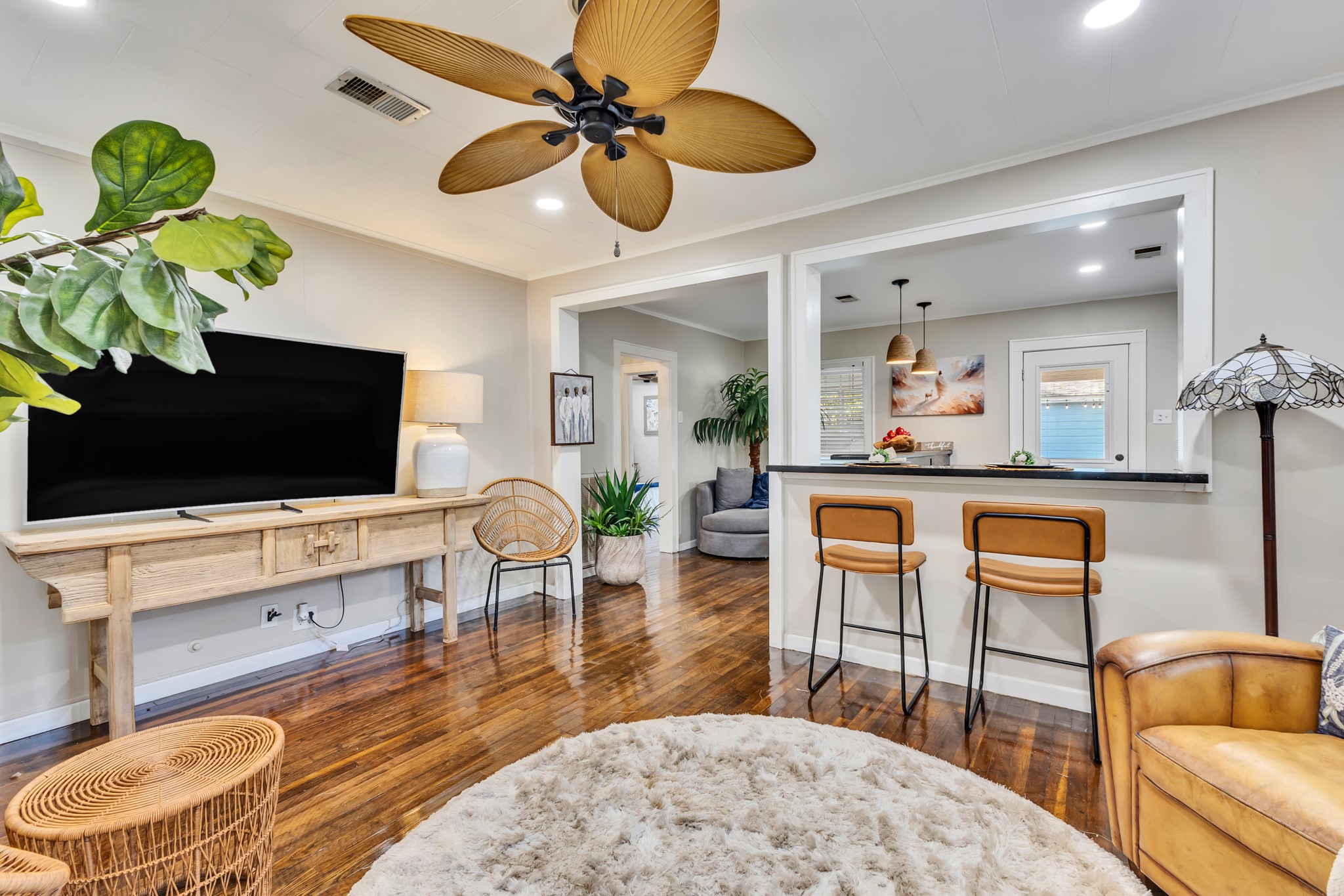 Enjoy the convenience of a living room that connects directly to the kitchen through a breakfast bar. This functional design keeps everyone connected, whether you're preparing meals, entertaining guests, or enjoying a quiet evening at home.