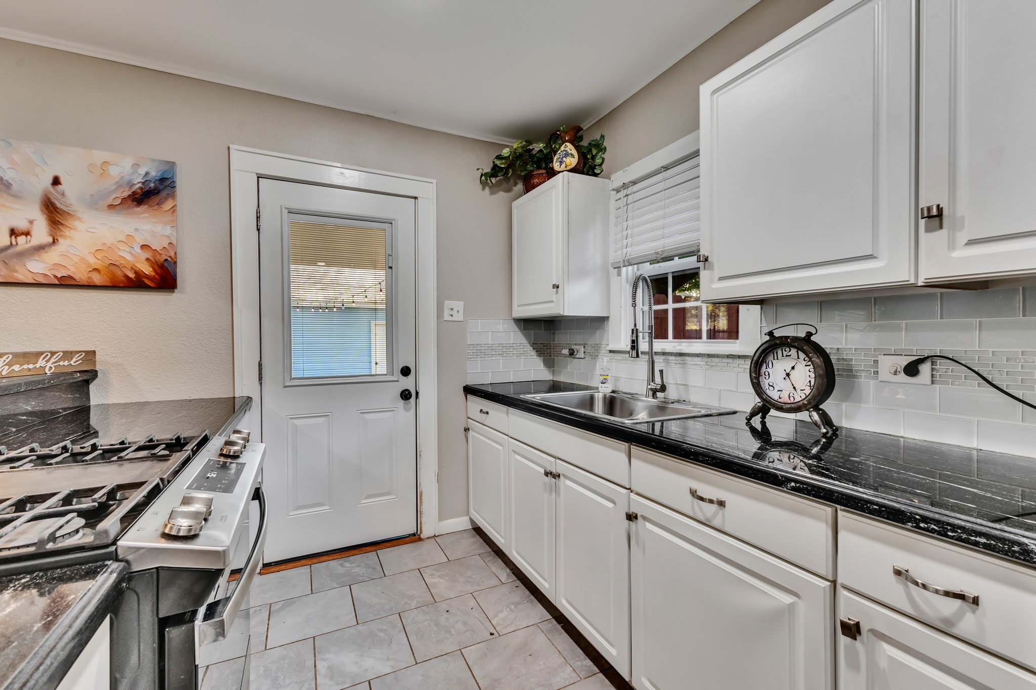 The kitchen's crisp cabinetry and coordinated finishes offer timeless appeal. With practical storage and counter space, this room provides the functionality buyers appreciate in a home of this size.