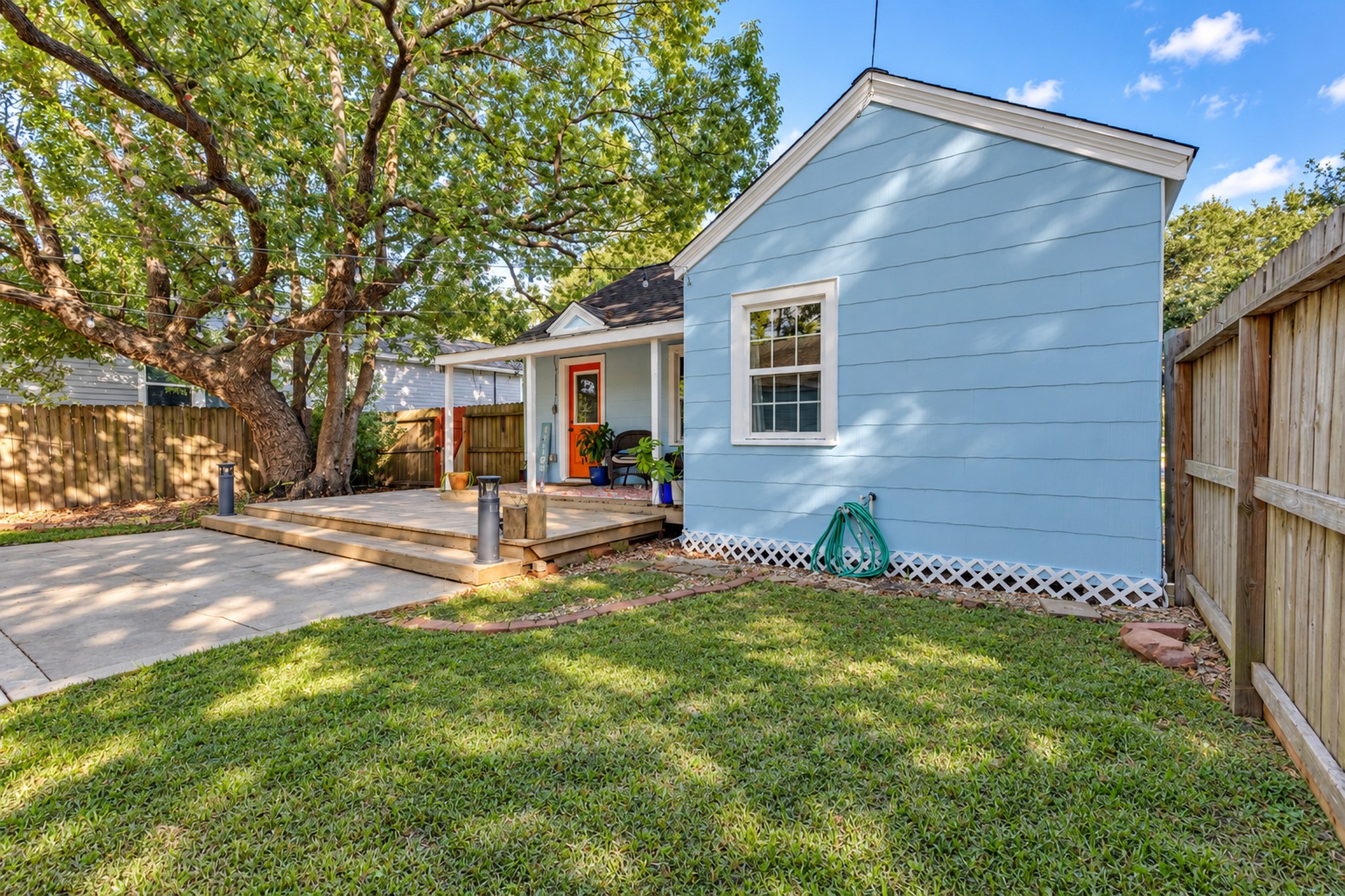 The generous grassy side yard adds valuable outdoor flexibility. Whether you envision a garden, outdoor activities, or simply appreciate having green space around your home, this property offers room to enjoy.
