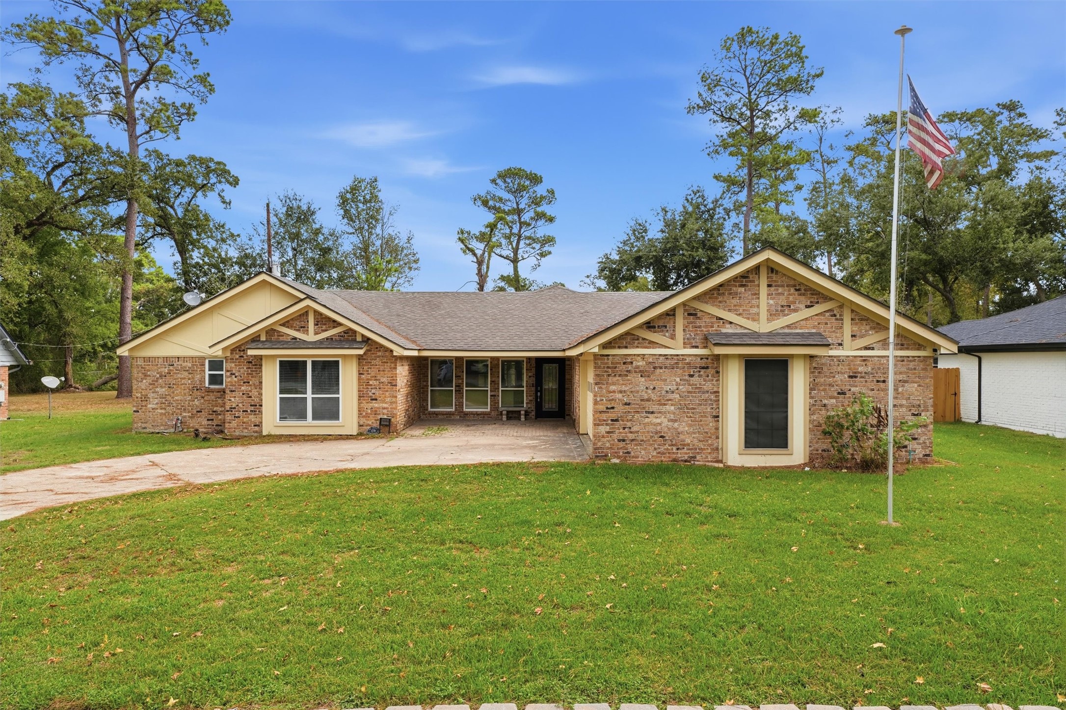 Daytime view of the home highlighting the covered front entry and decorative wood gables.