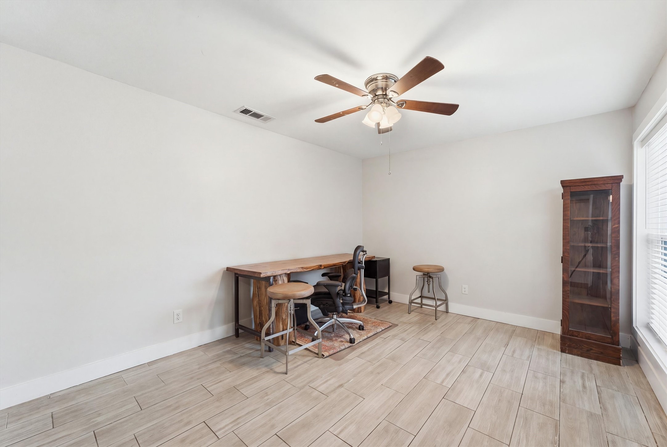 Located toward the front of the home, just off the living room and kitchen, this spacious flex area offers versatility as a home office, study, or casual gathering space for entertainment and game nights. Large windows bring in natural light, creating a bright and inviting atmosphere.